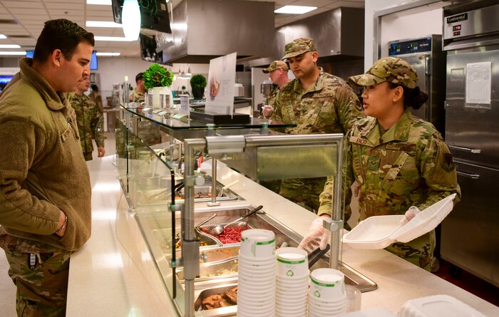 Senior Airman Jolin Encio, 9th Force Support Squadron food service specialist, servers an Airman at the Contrails Dining Facility at Beale Air Force Base, California