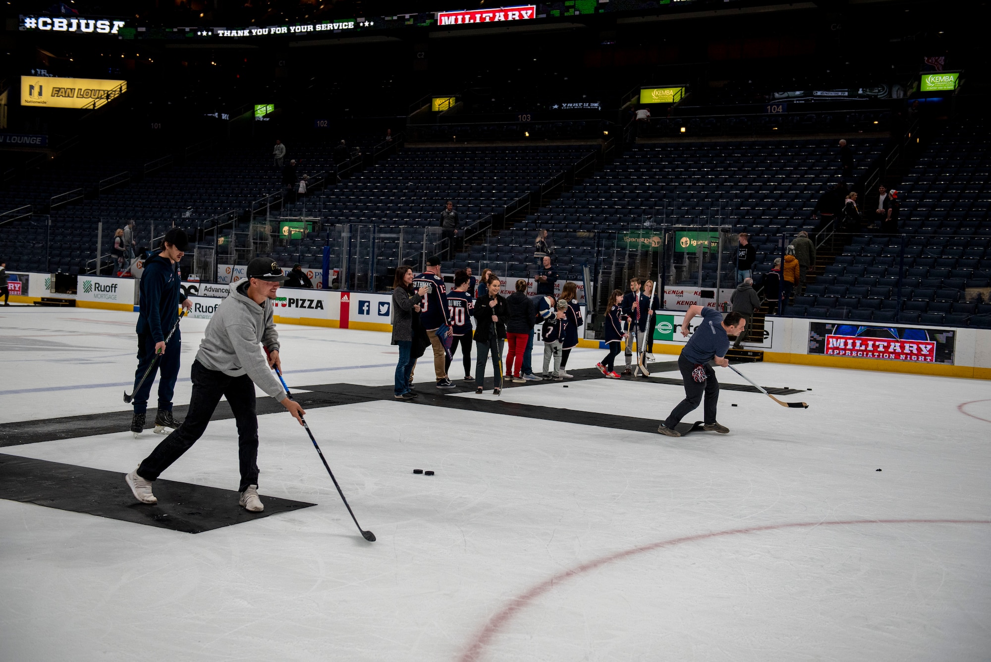 Fans and military veterans take the ice to hit slap shots April 7, 2022, following the game between the Columbus Blue Jackets and Philadelphia Flyers at Nationwide Arena, Columbus, Ohio. As part of their annual Military Appreciation Night, the Blue Jackets hosted a friendly alumni exhibition with the Wright Flyers, as well as several other recognition activities throughout the night. (U.S. Air Force photo by Senior Airman Jack Gardner)