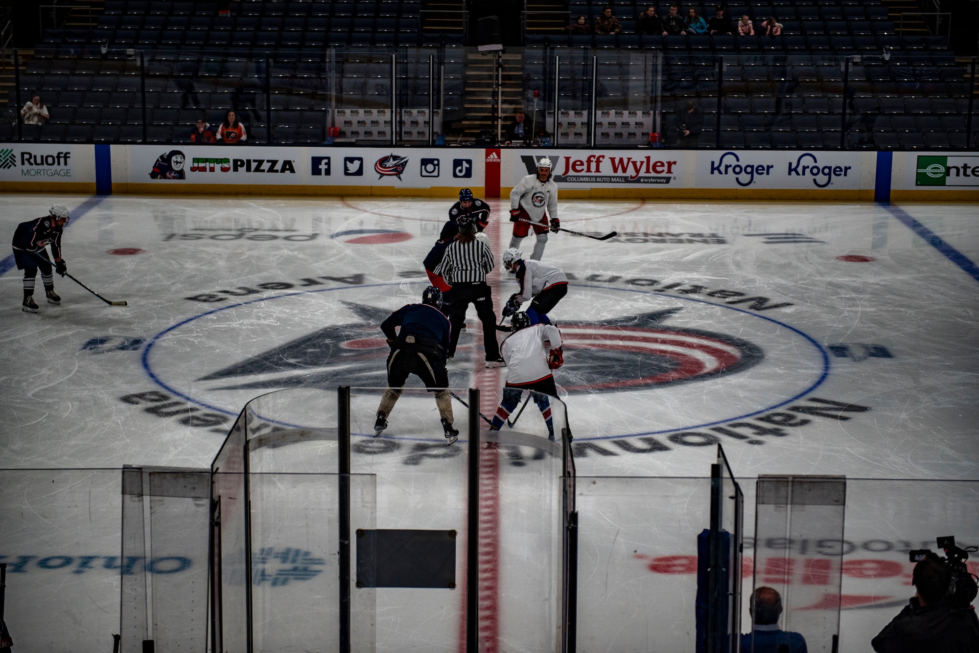 The Wright Flyers and former Columbus Blue Jackets players prepare for the puck drop to start a scrimmage  April 7, 2022, at Nationwide Arena, Columbus, Ohio. Prior to facing the Philadelphia Flyers, the Blue Jackets kicked off their annual Military Appreciation Night with a friendly exhibition game featuring Columbus alumni and the Wright Flyers, a recreation team made up of military and civilian personnel from Wright-Patterson Air Force Base.
(U.S. Air Force photo by Senior Airman Jack Gardner)