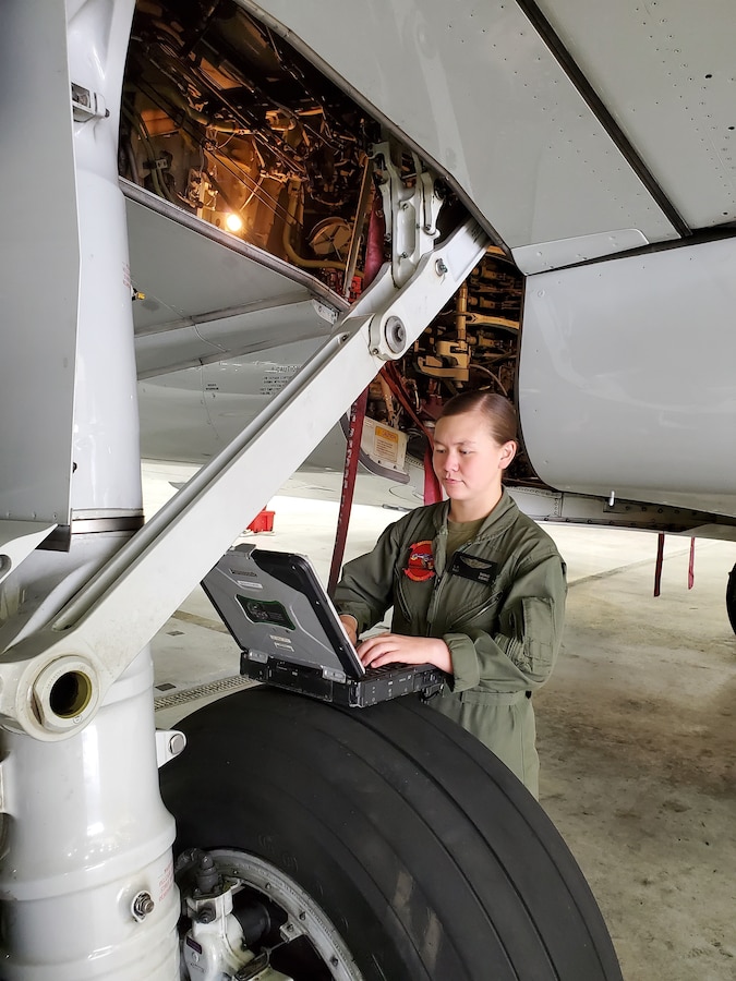 U.S. Marine Corps Staff Sgt. Song, a C-40A Clipper crew chief with Marine Transport Squadron 1, Marine Aircraft Group 41, Marine Forces Reserve, reviews training publications while conducting preventative maintenance on a C-40A Clipper at Naval Air Station Joint Reserve Base Fort Worth, Texas. (U.S Marine Corps photo by Sgt. Justin Bell)
