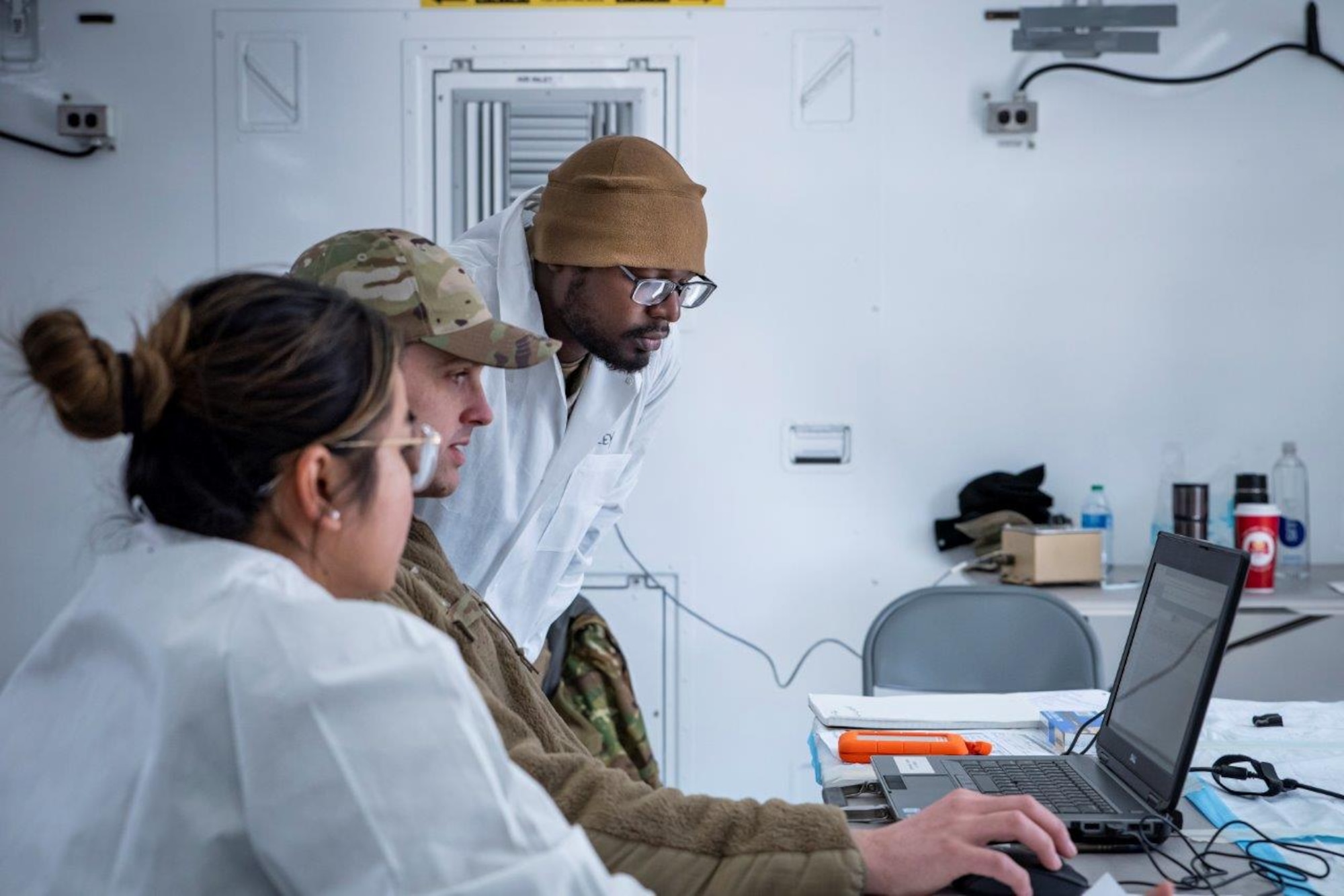 Staff Sgt. Atiba Timley, Staff Sgt. Justin Hart, and Staff Sgt. Rizamarie Arthur process radiological samples for analysis during a field exercise in March 2022 at the Warfighter Training Facility at Wright-Patterson Air Force Base. This exercise is part of the Air Force Radiation Assessment Team basic course at the USAF School of Aerospace Medicine. (U.S. Air Force photo / Richard Eldridge)