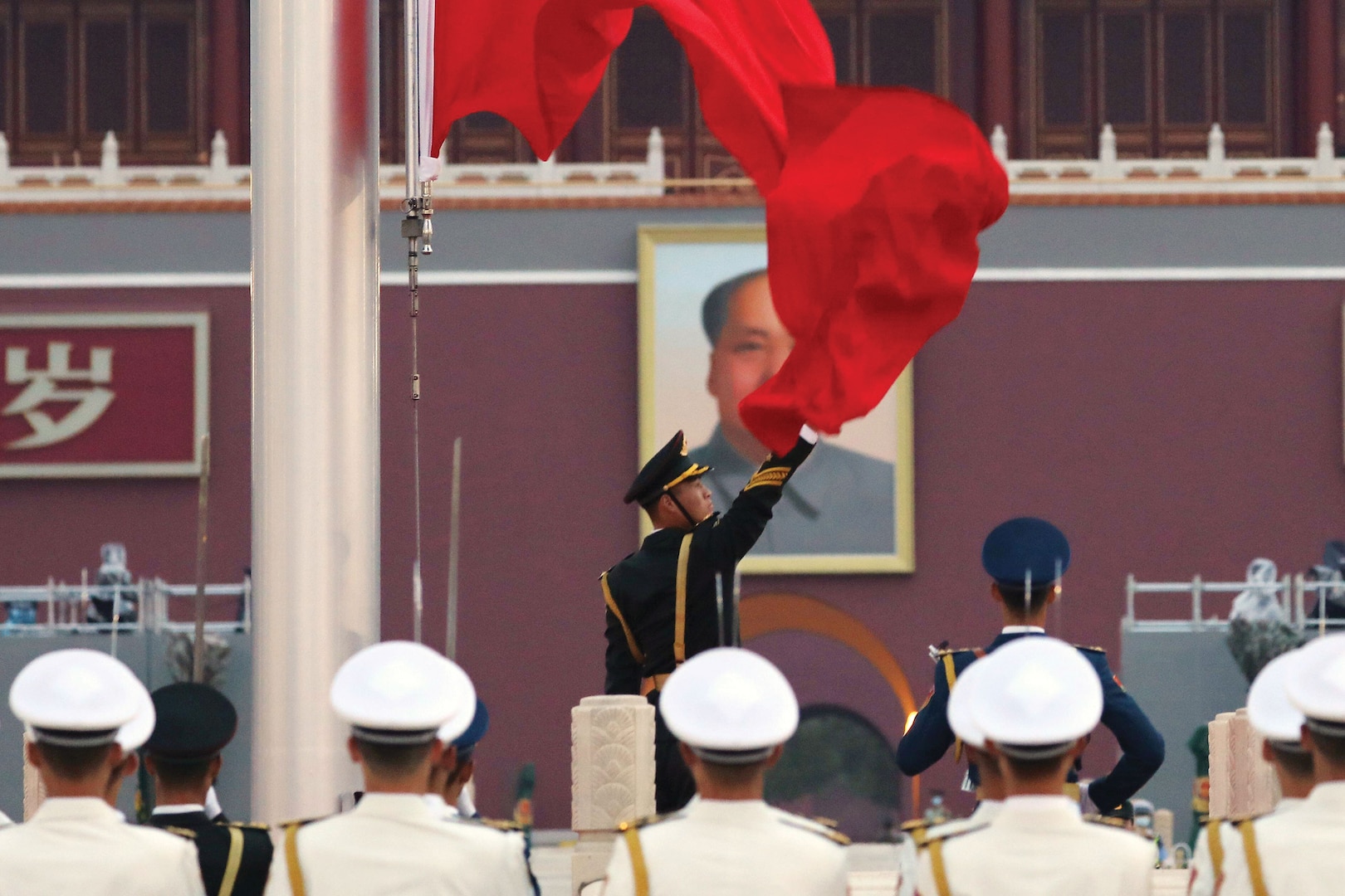 Members of China’s People’s Liberation Army attend flag-raising ceremony at Tiananmen Square, in Beijing, China, June 16, 2021 (Reuters/Tingshu Wang)