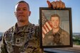 U.S. Army South Senior Enlisted Advisor, Command Sgt. Maj. Trevor C. Walker, holds a photo of himself as a specialist on JBSA - Fort Sam Houston, April 14, 2022. Walker was set to retire the next day after 32 years of service in the U.S. Army. (U.S. Army photo by Spc. Joshua Taeckens)