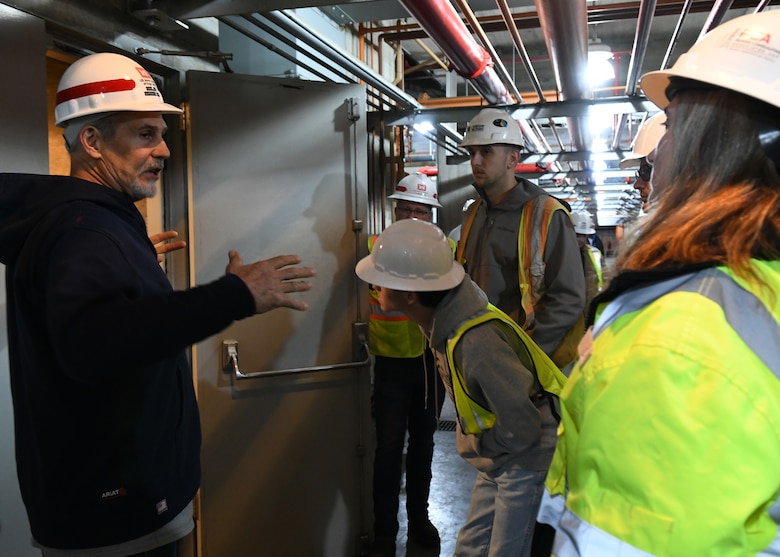 Lipscomb University students peer up at a generator turbine located underground at the Old Hickory Powerplant in Hendersonville, Tennessee as Power Plant Manager Joseph Conatser explains the process of converting water into energy.