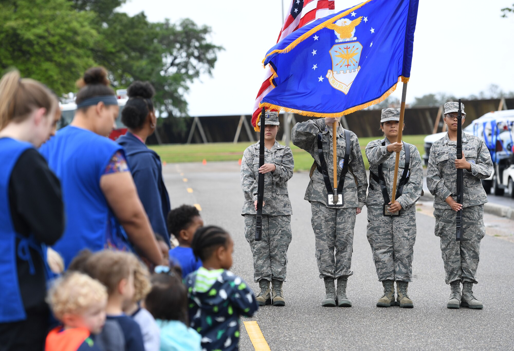 Members of the Biloxi High School Air Force Junior ROTC present the colors during the Keesler Child Development Center parade at Keesler Air Force Base, Mississippi, April 14, 2022. The parade was held in recognition for the Month of the Military Child, which is celebrated throughout the month of April. (U.S. Air Force photo by Kemberly Groue)