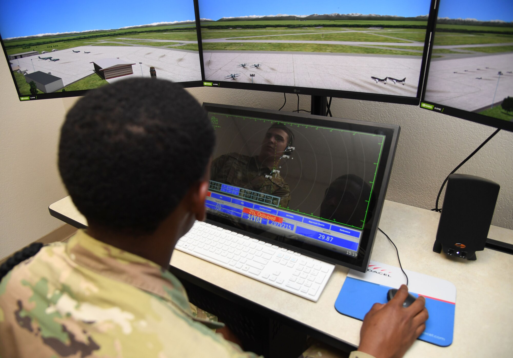 U.S. Air Force Airmen Jayden Ali and Luke Pietrykowski, 334th Training Squadron students, use a condensed air traffic control tower simulator for training inside Erwin Manor at Keesler Air Force Base, Mississippi, April 13, 2022. Four trainers were installed to allow students the opportunity to increase tower control contact hours and to provide students additional study and familiarization time outside the classroom. (U.S. Air Force photo by Kemberly Groue)