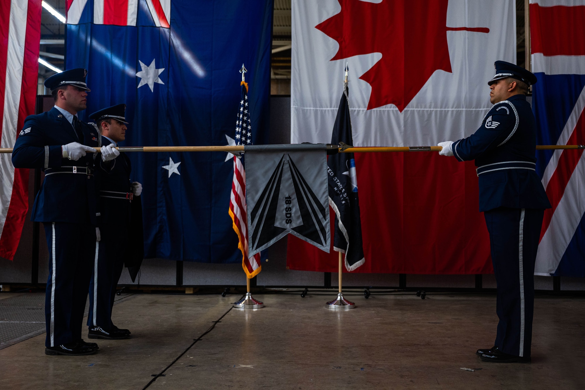 Members of the Vandenberg Space Force Base Honor Guard team unfurl the new 18th Space Defense Squadron’s flag during a re-designation ceremony at Vandenberg SFB, Calif., April 13, 2022. The 18th Space Control Squadron was re-designated as the 18 SDS to signify increased focus on Space Domain Awareness (SDA) command and control, integrating and synchronizing SDA capabilities in support of the contested and congested domain, and collaboration with allies and partners. The furling and unfurling of flags have been a long standing tradition in ceremonies to symbolize the activation, deactivation or re-designation of units. (U.S. Space Force photo by Tech. Sgt. Luke Kitterman)
