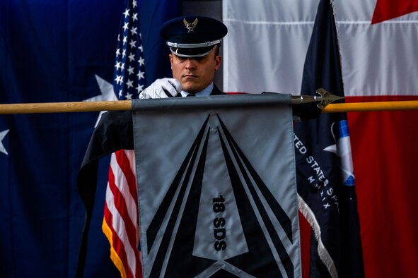 U.S. Air Force Senior Airman Mark Macias, member of the Vandenberg Space Force Base Honor Guard team and assigned to the 30th Civil Engineer Squadron, covers the 18th Space Defense Squadron’s previous unit flag behind the unit’s new flag during a re-designation ceremony at Vandenberg Space Force Base, Calif., April 13, 2022. The 18 SDS, previously 18th Space Control Squadron, will continue to be U.S. Space Command’s premier provider of continuous, comprehensive and combat-relevant space domain awareness. (U.S. Space Force photo by Tech. Sgt. Luke Kitterman)
