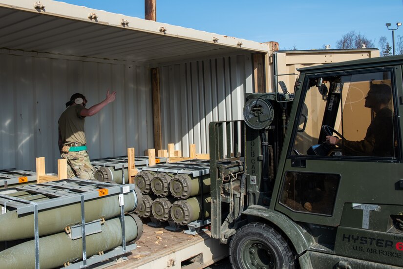 A photo of Airmen offloading munitions.