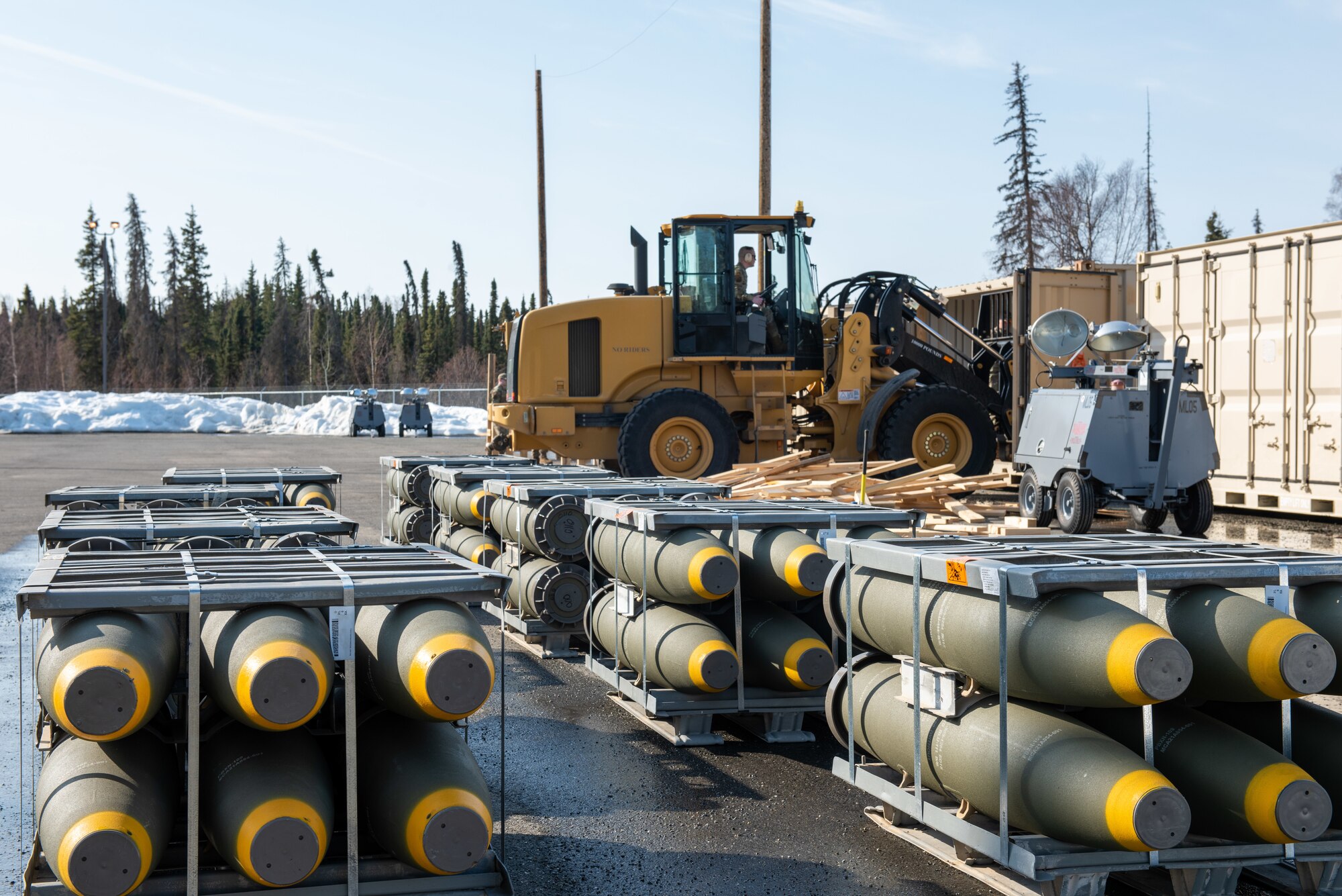 A photo of Airmen offloading munitions from a shipping container.