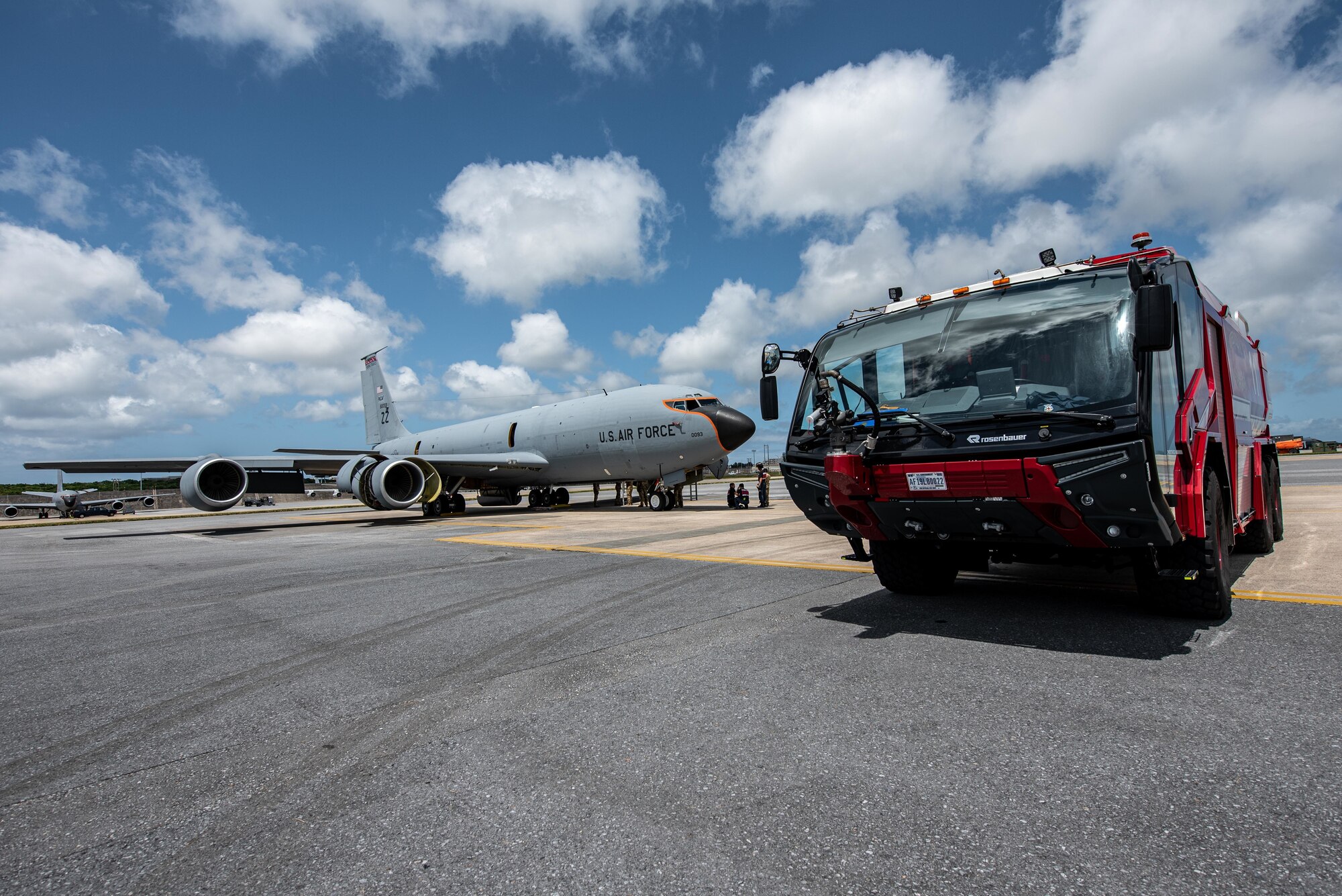 Firetruck is parked next to a KC-135.