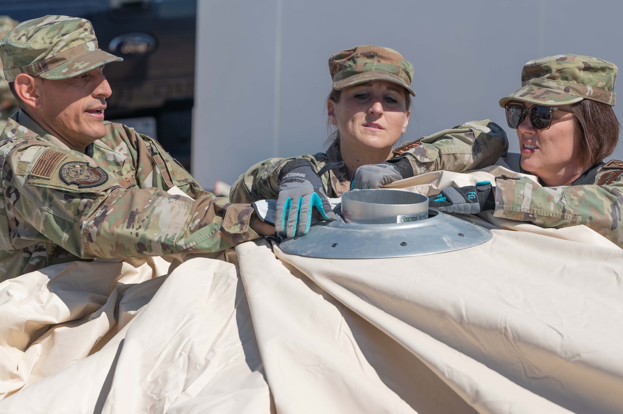 From left, Staff Sgt. Alejandro Guzman, Tech. Sgt. Christine Sulwer, and Master Sgt. Rachael Kargol, 162nd FSS Specialists, erect a massive tent structure for use during an in-person combined training event with other Air and Army National Guard units this week in Las Vegas.
