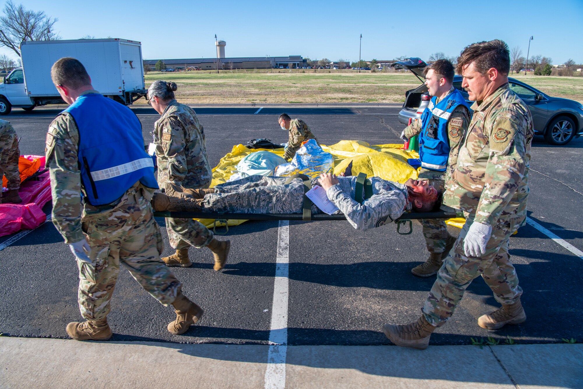 Airmen from the 22nd Medical Group carry a simulated casualty to the medical clinic during Exercise Ready Eagle April 8, 2022, at McConnell Air Force Base, Kansas.