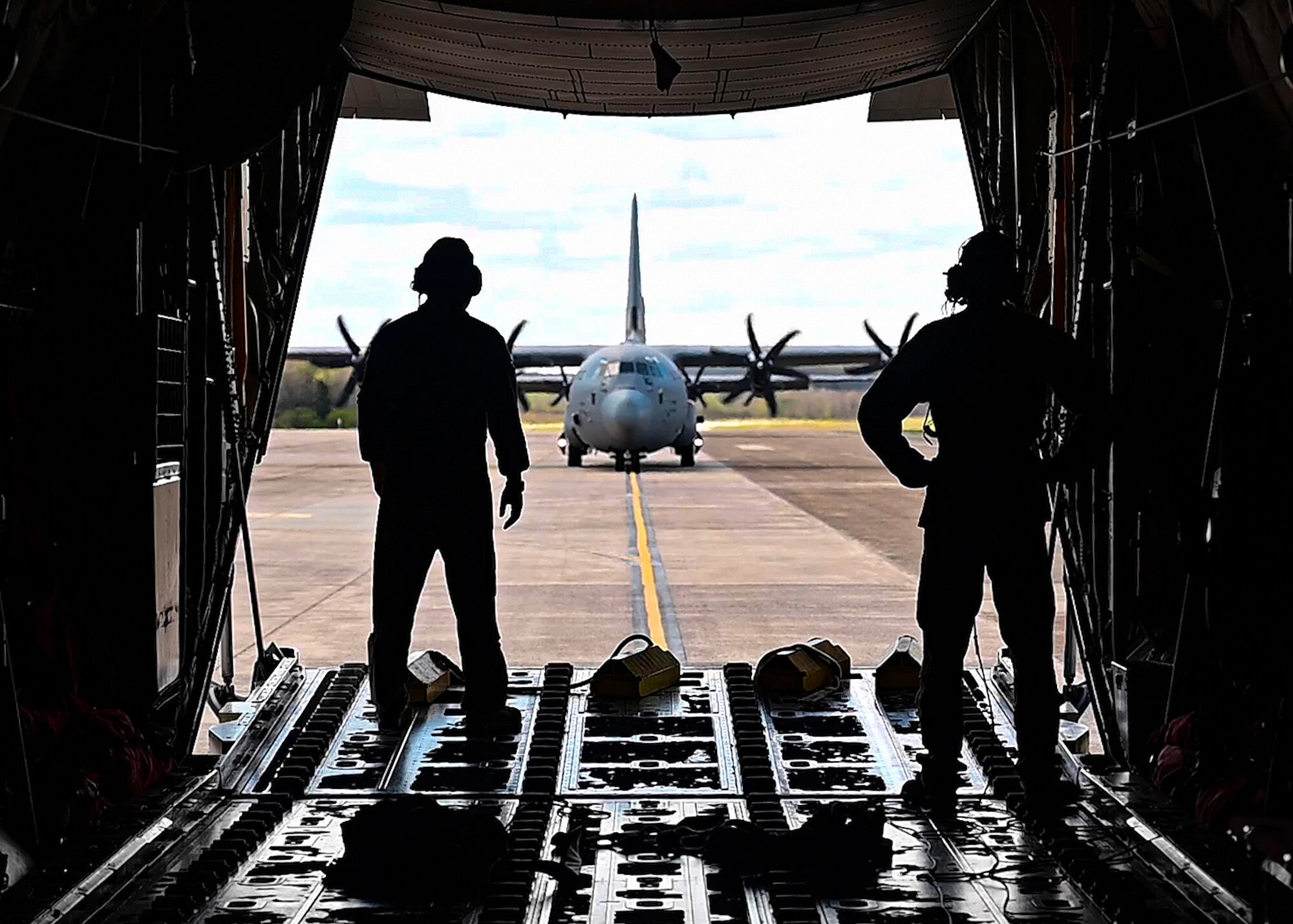 Loadmasters from the 29th Weapons Squadron stand on the ramp of a C-130J Super Hercules