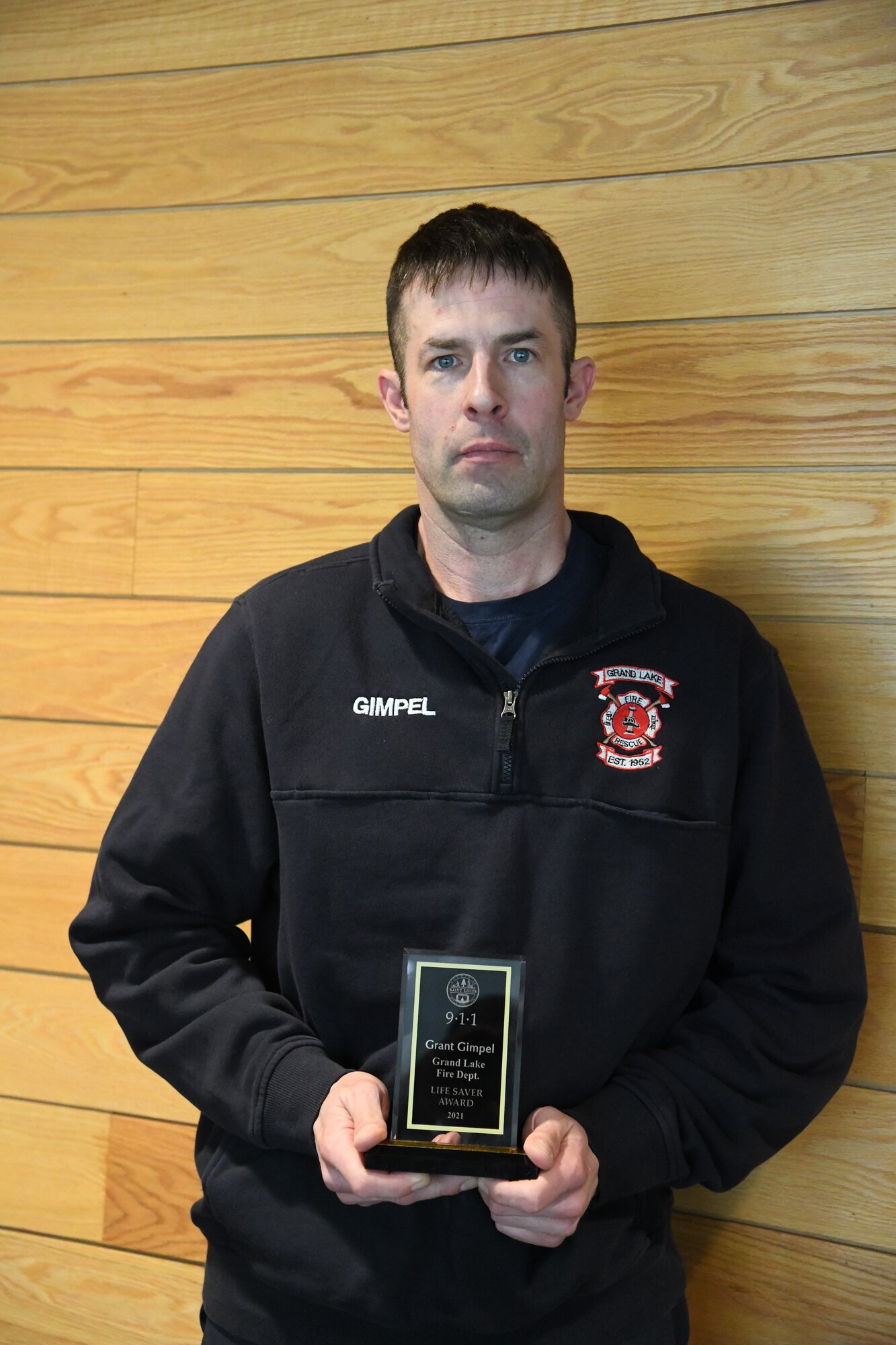 Master Sgt. Grant Gimpel displays a “Life Saver” award that he received from St. Louis County Sheriff Ross Litman, April 12, 2022, Duluth, Minn. Gimpel was recognized for being part of a team of volunteer fire fighters that helped save a person experiencing cardiac arrest in January 2021.