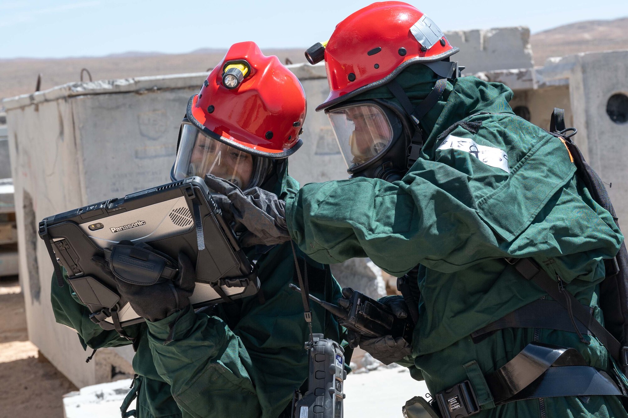 Master Sgt. Rachael Kargol and Staff Sgt. Alejandro Guzman, FSS Specialists who have volunteered for the 162nd FSS FSRT mission, mark the location of simulated human remains during an in-person combined training event with other Air and Army National Guard units this week in Las Vegas.