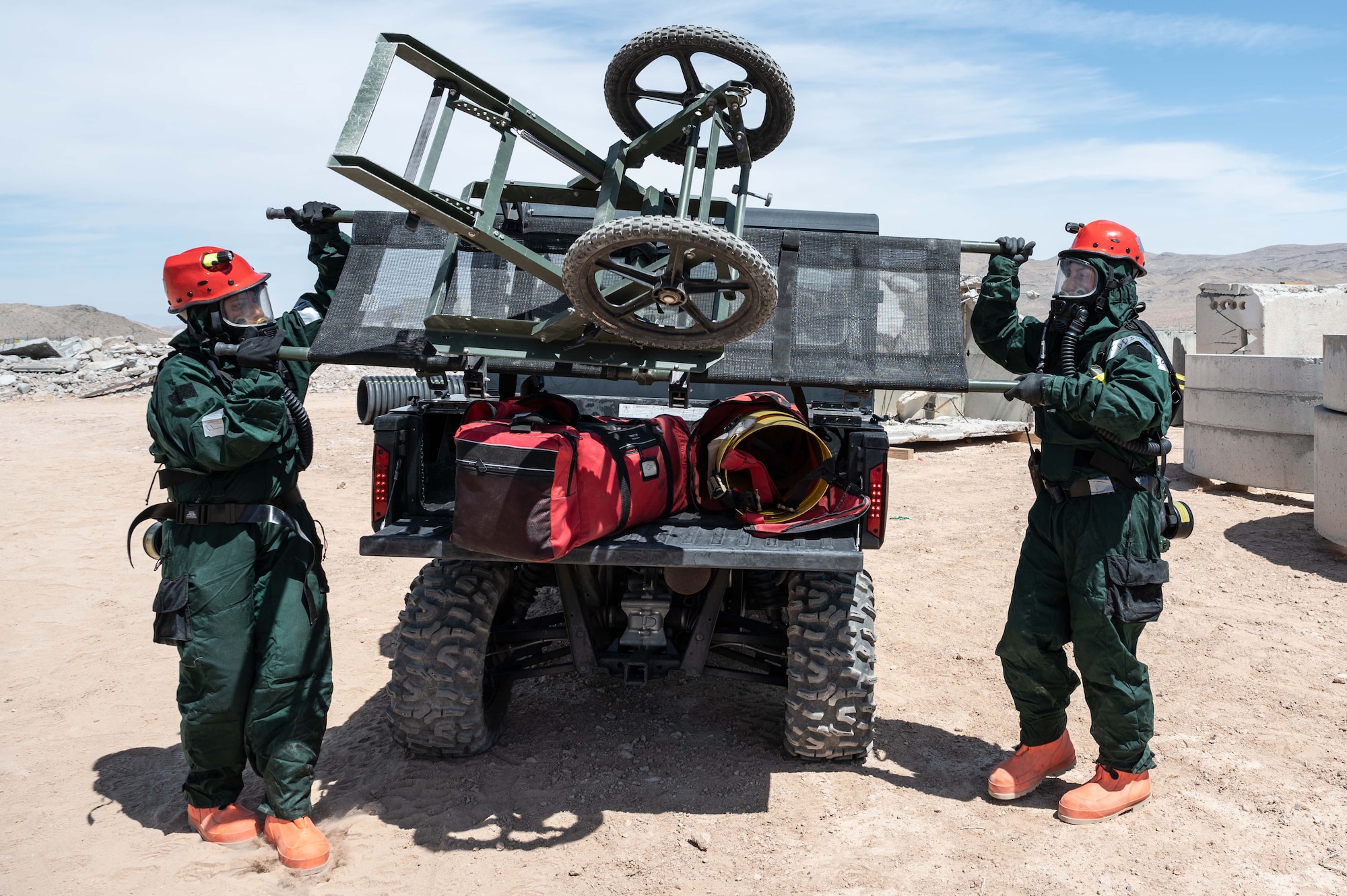 Master Sgt. Rachael Kargol and Tech. Sgt. Daniel Dumbrique, FSS Specialists who have volunteered for the 162nd FSS FSRT mission, remove a litter from their vehicle to transport simulated human remains during an in-person combined training event with other Air and Army National Guard units this week in Las Vegas.