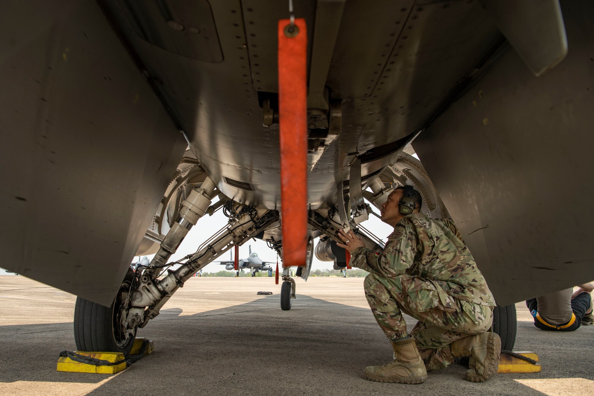 A maintainer works on an F-16.