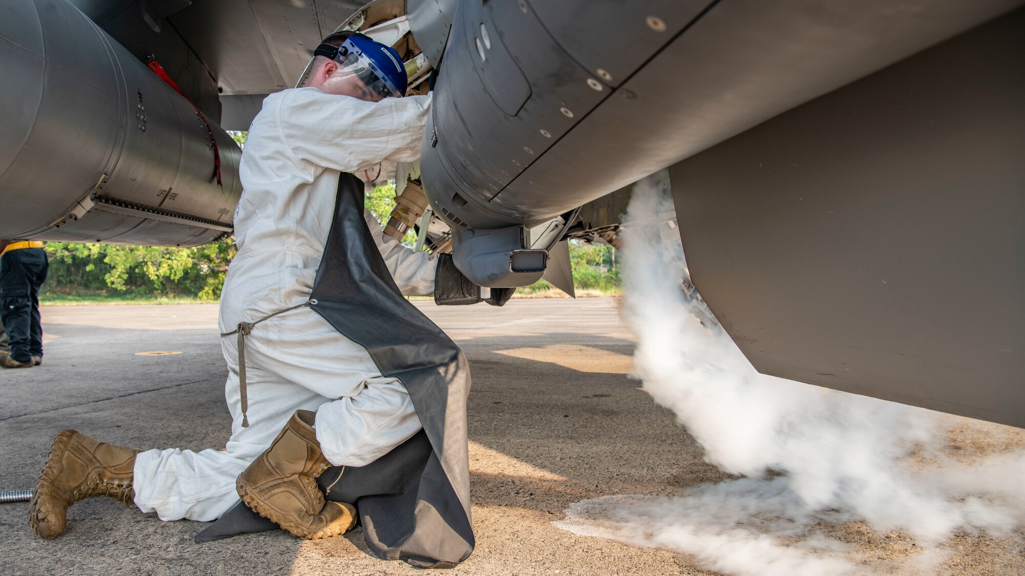 An Airman works on filling an F-16 with liquid oxygen.