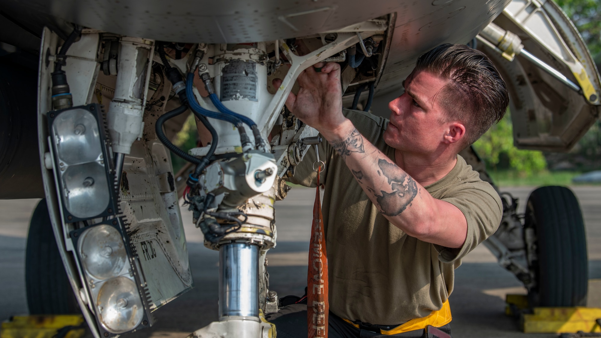 A maintainer works on an F-16.