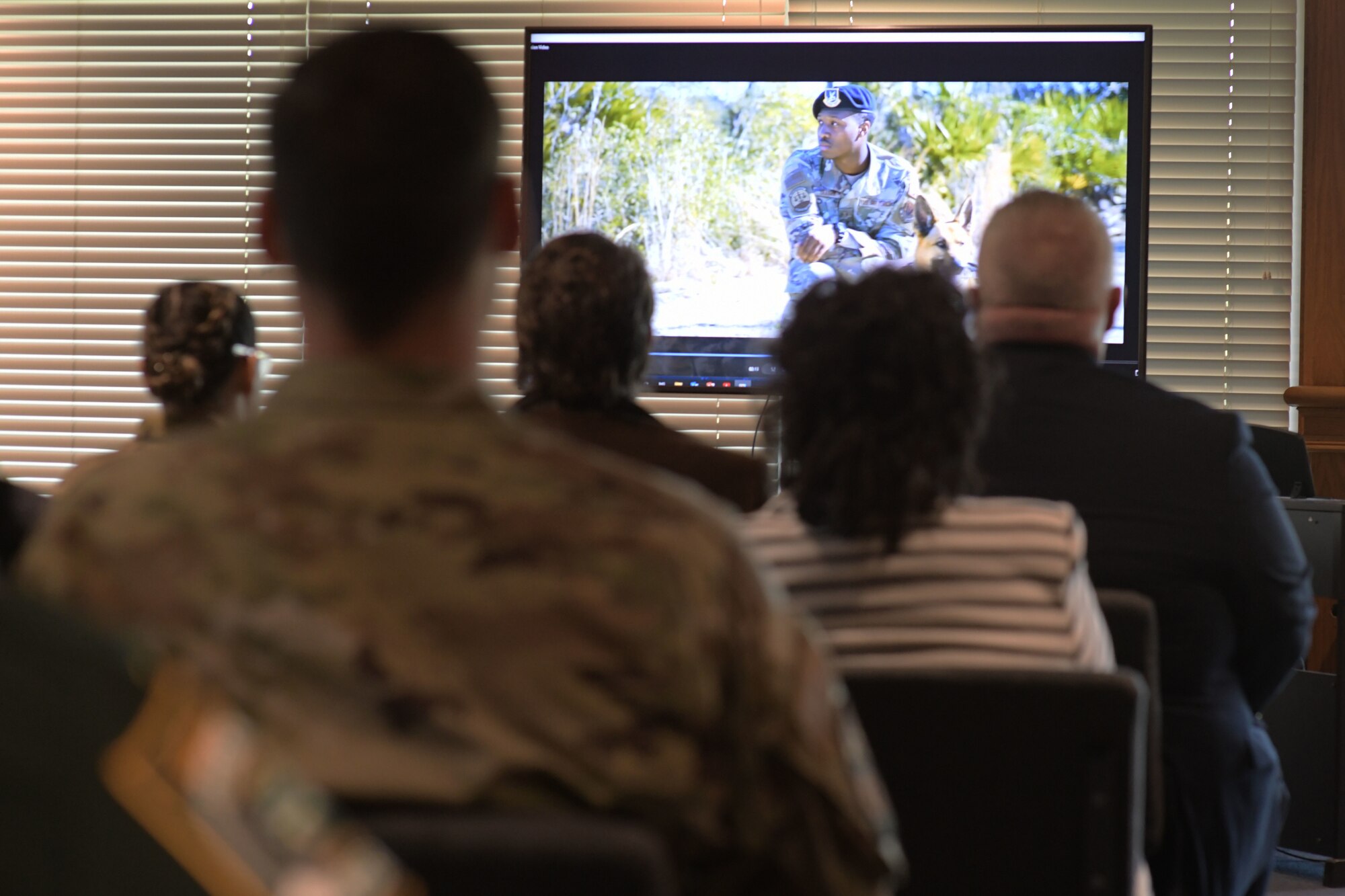 The newest class of Tyndall Air Force Base’s honorary commanders watch a video detailing the base’s mission with their respective commanders at Tyndall Air Force base, Florida, April 13, 2022
