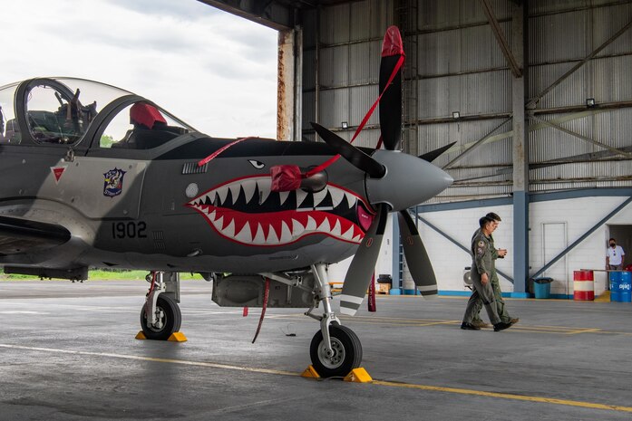 Former classmates U.S. Air Force Maj. Dan Jackson, 6th Special Operations Squadron combat aviation advisor evaluator pilot, and Philippine Air Force Maj. Dennis Marzo, right, 15th Strike Wing A-29 pilot, discuss joint tactics during exercise Balikatan at Clark Air Base, Pampanga, Philippines, April 5, 2022