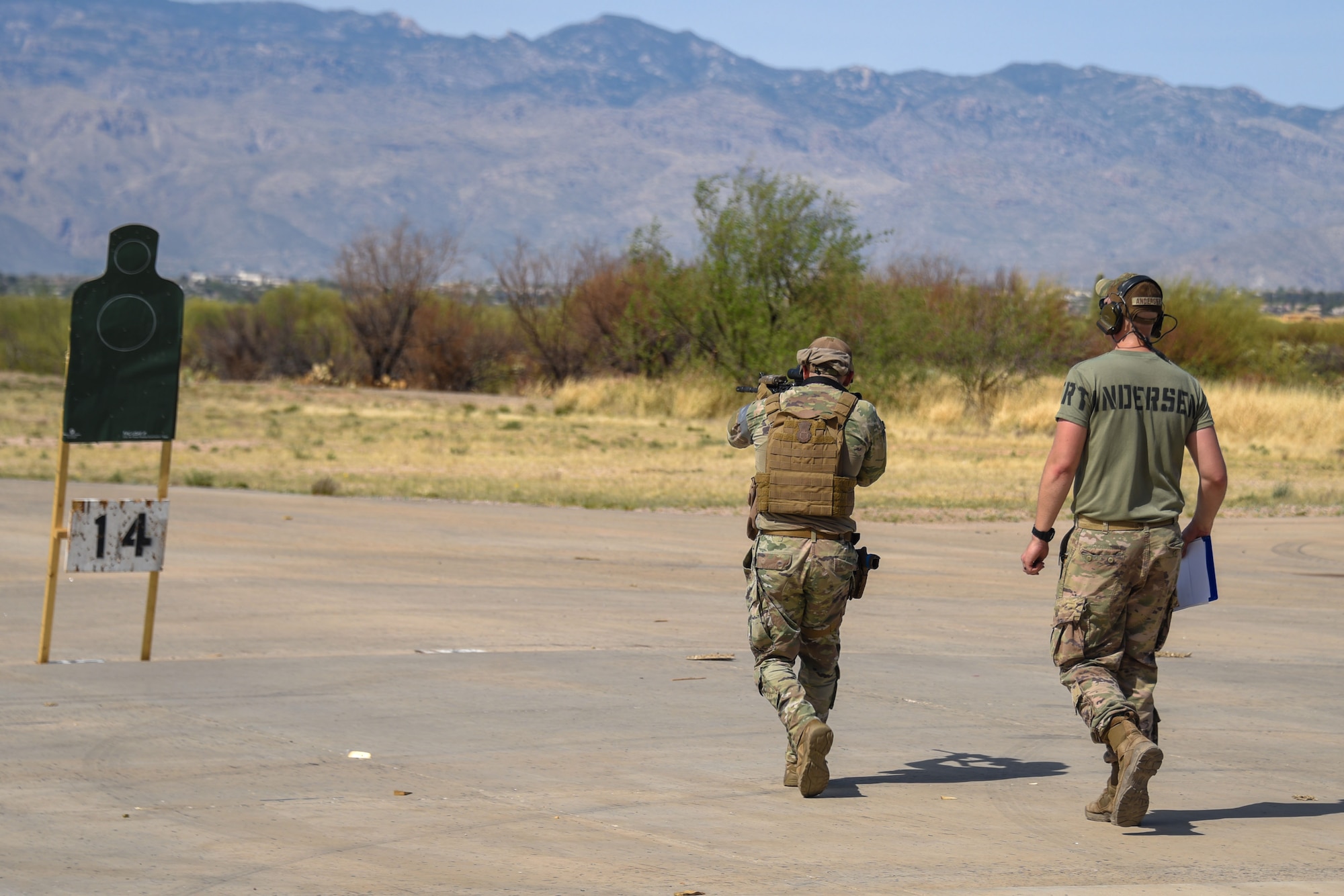 A photo of an Airman firing at a target.