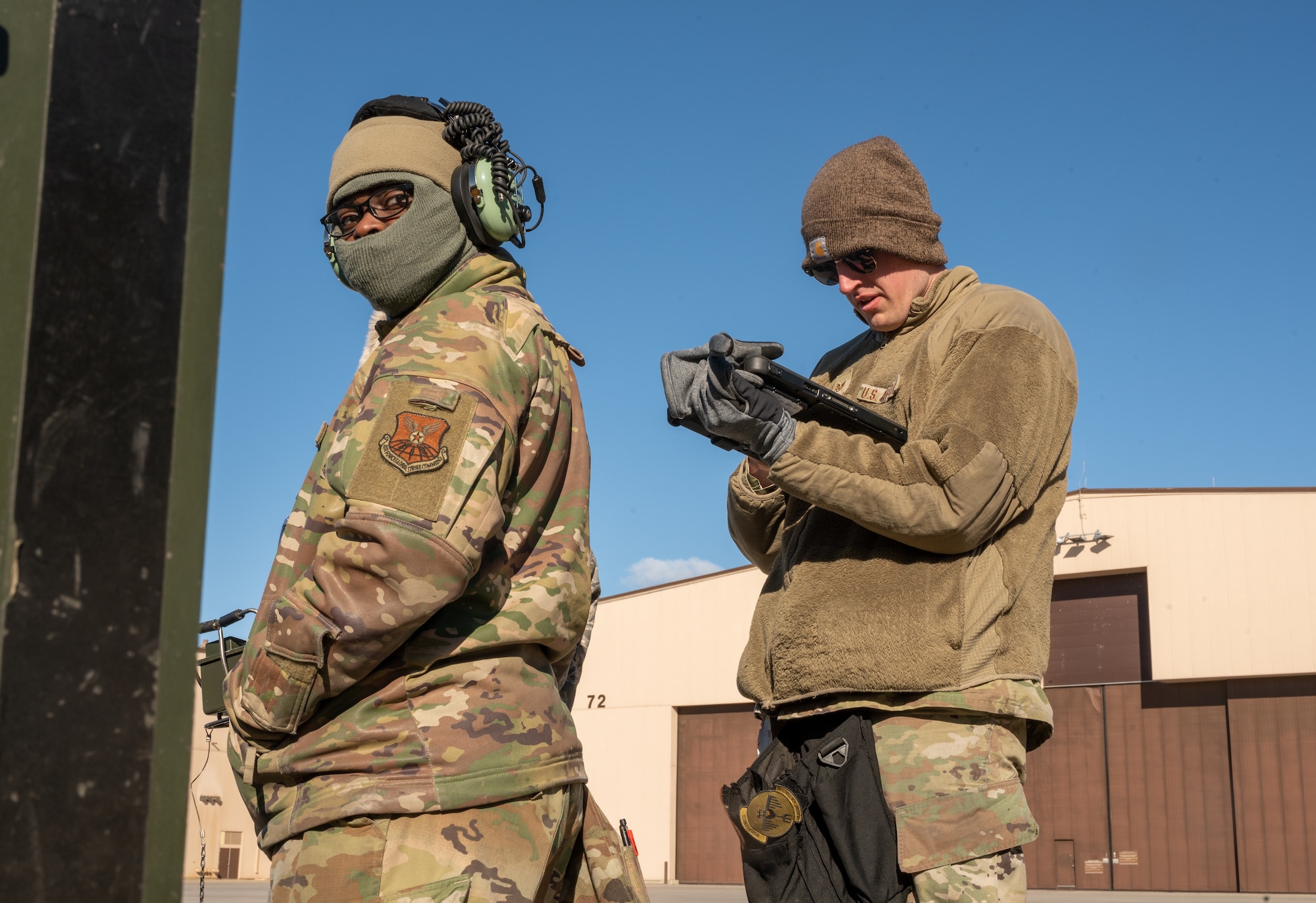 Airman 1st Class Keith Williams, 28th Aircraft Maintenance Squadron weapons load crew member, left, and Staff Sgt. Zachary Linder, 28th AMXS weapons load team chief, right, go through a checklist of technical orders during a Major Aircraft Generation Exercise at Ellsworth Air Force Base, S.D., April 14, 2022. These checklists allow members to execute the steps it takes to correctly load weapons onto the B-1B Lancer in a timely manner. (U.S. Air Force photo by Senior Airman Michael Ward)