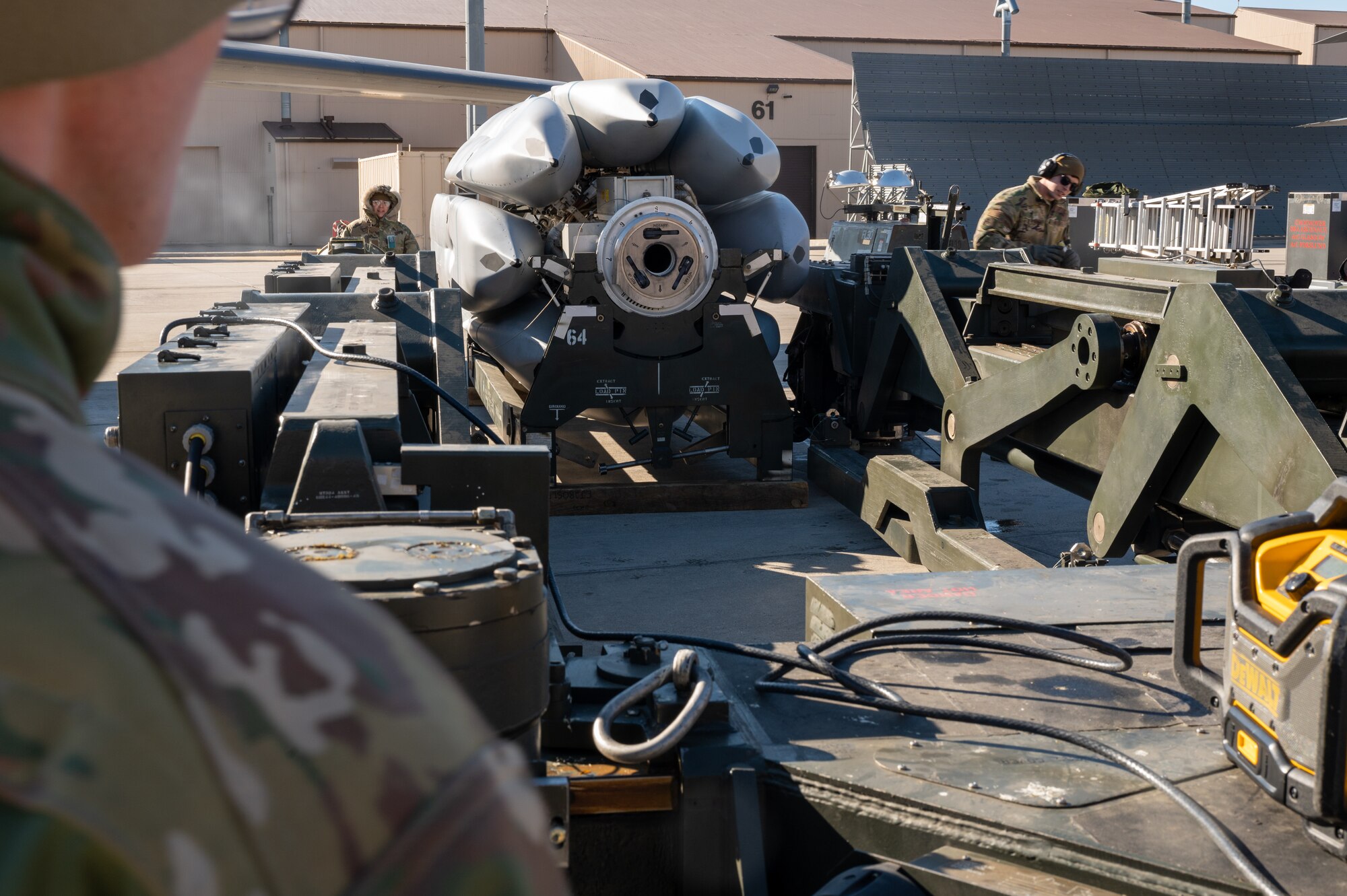 Members of the 28th Maintenance Group practice loading a Joint Air-to-Surface Standoff Missile onto a B-1B Lancer during a Major Aircraft Generation Exercise at Ellsworth Air Force Base, S.D., April 14, 2022. The exercise was held to test 28th MXG Airmen and their ability to prepare weapons and aircraft on an accelerated timeline. (U.S. Air Force photo by Senior Airman Michael Ward)