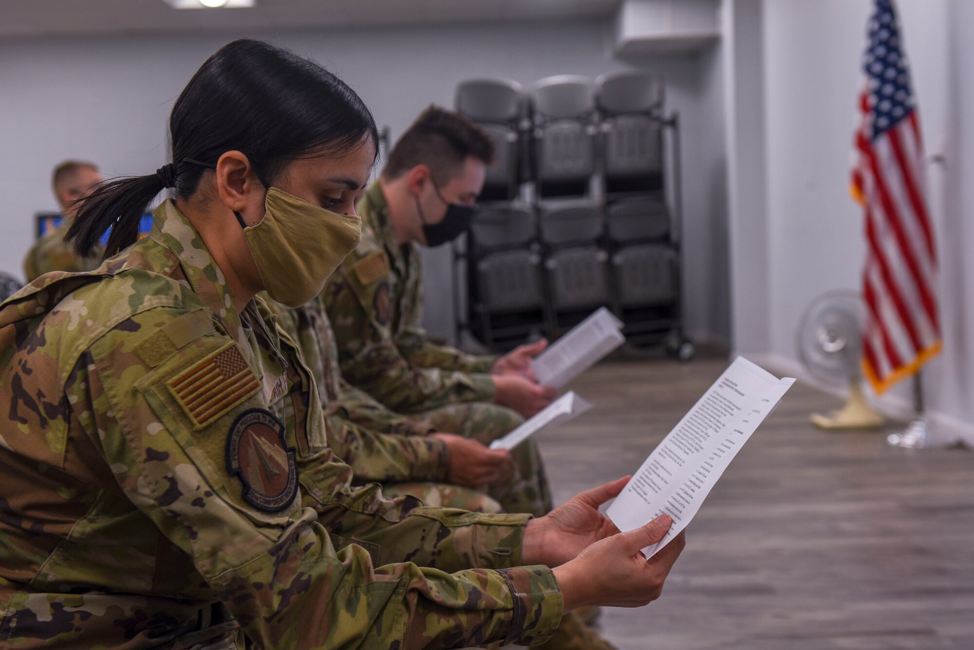 An Airman reads a pamphlet before a lecture.