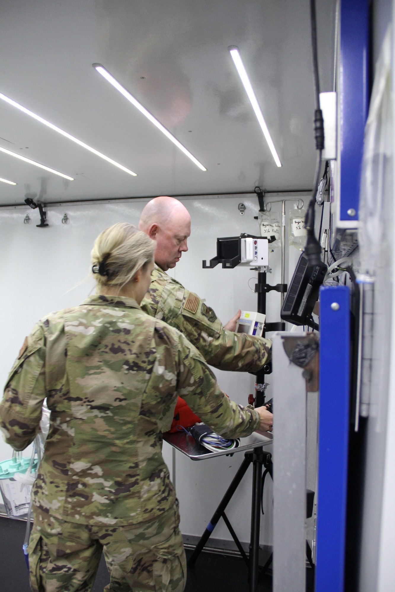 Maj. Kevin Smith, trauma nurse, 130th Medical Group, Charleston, West Virginia, Air National Guard; and Maj. Danielle Betz, emergency physician, 48th Medical Group, RAF Lakenheath, U.K. set up prototype B of the of the tactical anesthesia workstation (TAW), for the first time April 8, 2022, during a Ground Surgical Team (GST), training course at U.S. Air Force School of Aerospace Medicine at Wright-Patterson Air Force Base, Ohio. Maj. Thomas Heering, an austere anesthesia cadre for the GST, 711th Human Performance Wing, Air Force Research Laboratory, submitted the TAW idea to Spark Tank in 2021, and the idea moved forward with a team of engineers in the rapid prototyping cell (RPC). The RPC team developed the three prototypes for testing beginning in January 2022, and have since narrowed it down to one winning prototype. The team with push the recommended prototype to the GST pilot group for further deliberation. (U.S. Air Force photo/Aleah Castrejon)