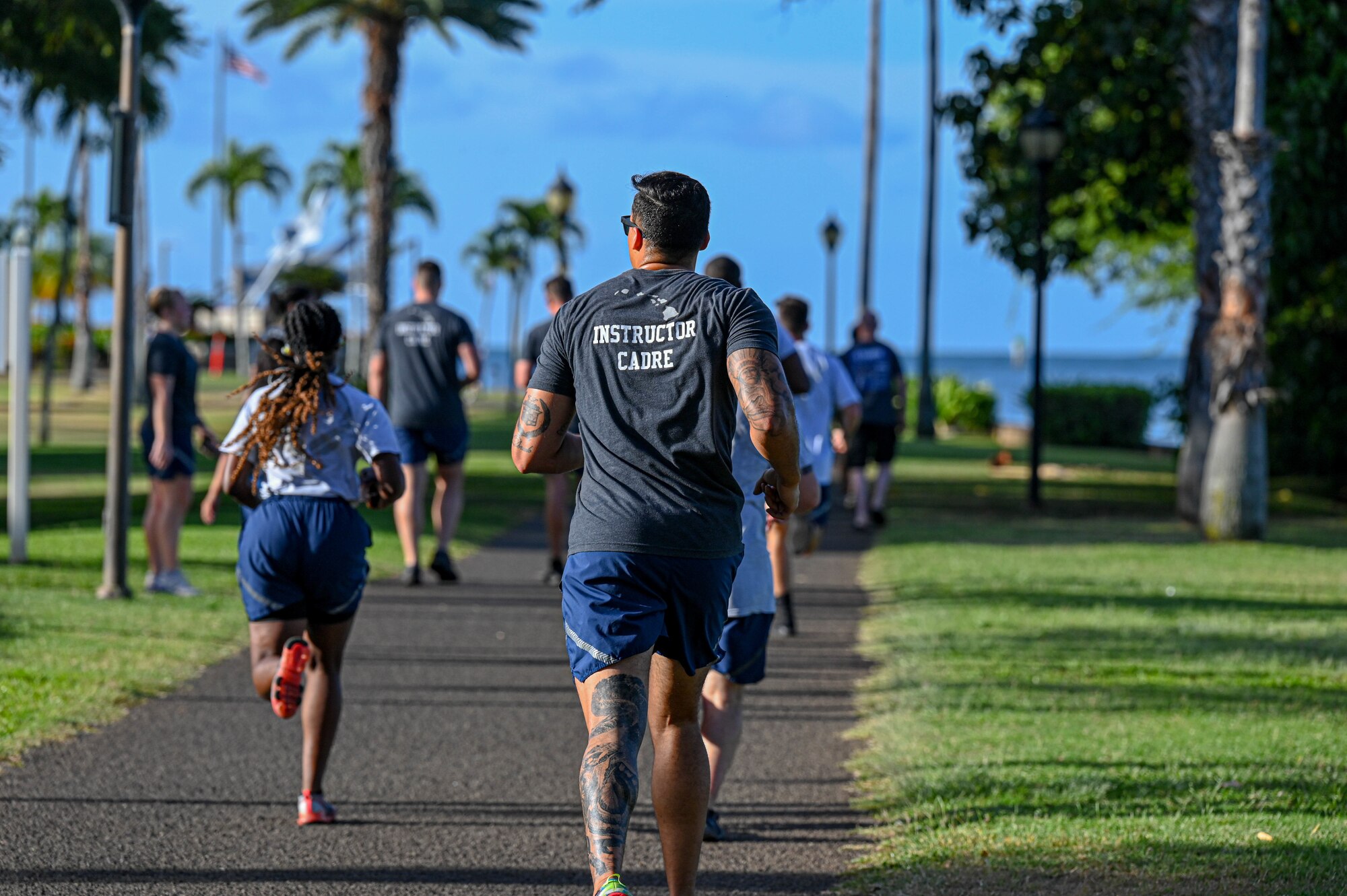 Cadre and students attending the Noncommissioned Officer Academy at the Binnicker Professional Military Education Center finish up a school run at Joint Base Pearl Harbor-Hickam, Hawaii, April 14, 2022. The goal of the NCOA program is to provide the best academic program possible by instilling relevant and solution-focused leadership attributes to enhance military organizations. (U.S. Air Force photo by 1st Lt. Benjamin Aronson)