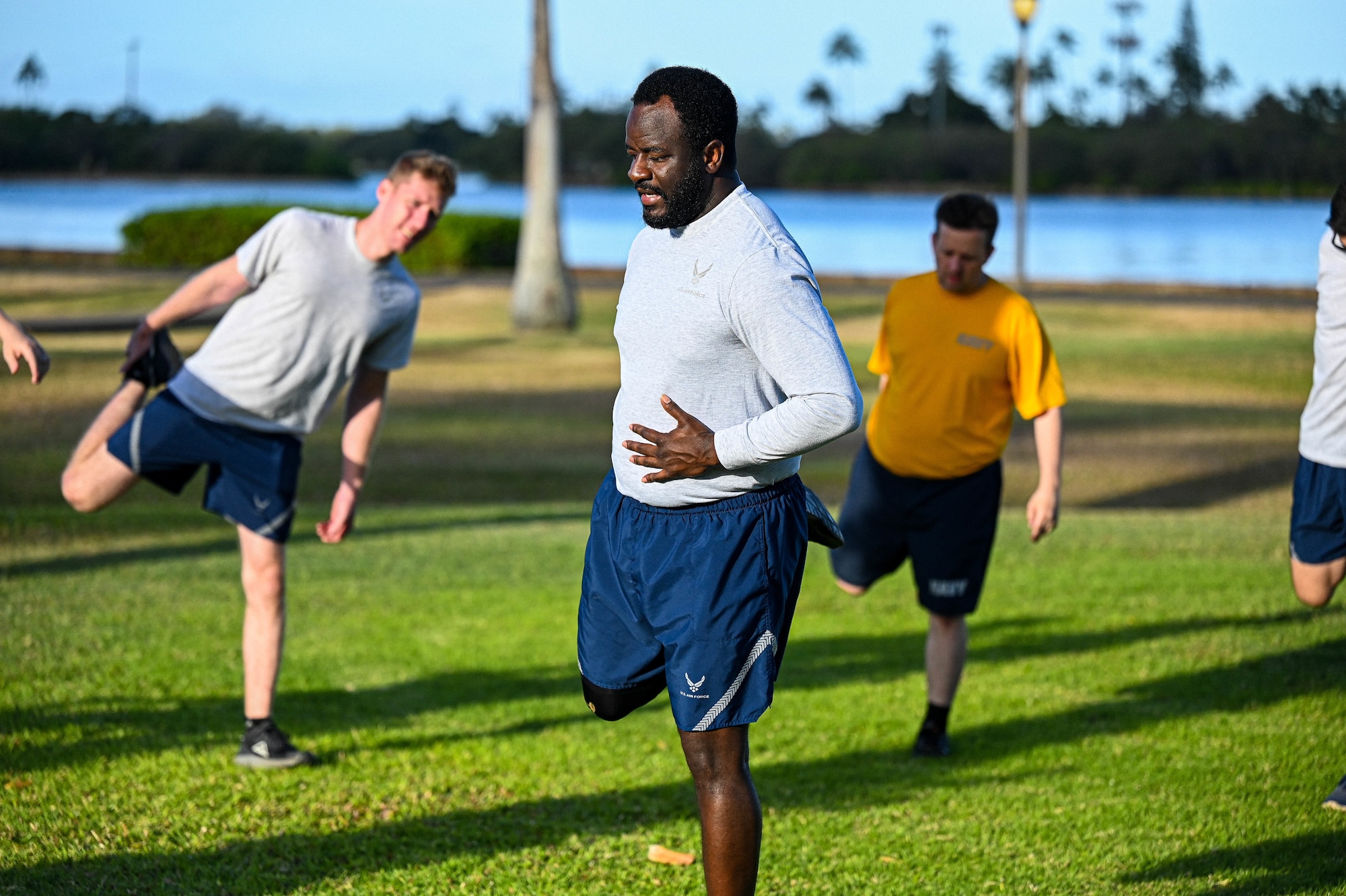 Tech. Sgt. Zavier LeGrand, Noncommissioned Officer Academy student, leads his flight in stretches before a school run at Joint Base Pearl Harbor-Hickam, Hawaii, April 14, 2022. The Binnicker Professional Military Education Center at JBPHH is one of 11 centers that host NCOA worldwide. (U.S. Air Force photo by 1st Lt. Benjamin Aronson)