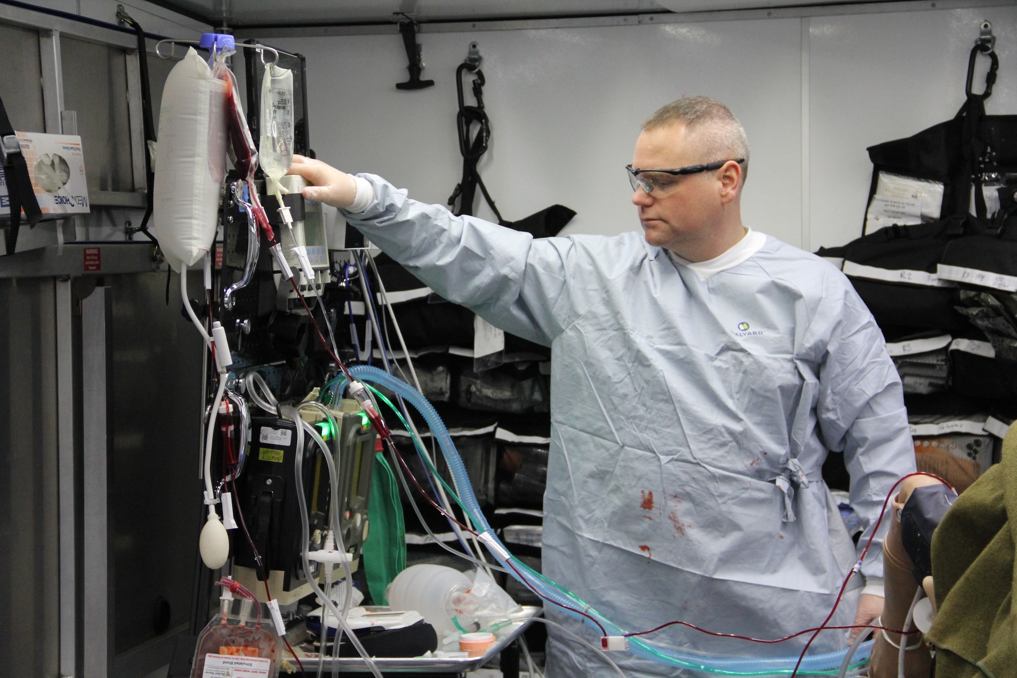 Maj. Adam Faltersack, an anesthesia element chief, 81st Surgical Operations Squadron, Keesler Air Force Base, Mississippi, uses prototype A of the tactical anesthesia workstation, or TAW, April 8, 2022, during a Ground Surgical Team, or GST, training course at U.S. Air Force School of Aerospace Medicine at Wright-Patterson Air Force Base, Ohio. Maj. Thomas Heering, an austere anesthesia cadre for the GST, 711th Human Performance Wing, Air Force Research Laboratory, submitted the TAW idea to Spark Tank in 2021, and the idea moved forward with a team of engineers in the rapid prototyping cell, or RPC. The RPC team developed the three prototypes for testing beginning in January 2022, and have since narrowed it down to one winning prototype. The team will push the recommended prototype to the GST pilot group for further deliberation. (U.S. Air Force photo/Aleah Castrjon)