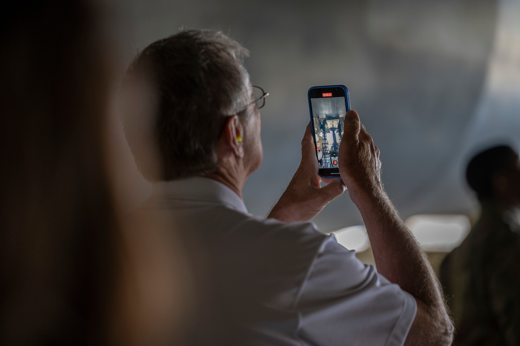 David Smith, Abilene Military Affairs Committee member, records a video of munitions being loaded onto a B-1B Lancer by weapons load crew members assigned to the 7th Aircraft Maintenance Unit during a Load of the Quarter competition at Dyess Air Force Base Texas, April 14, 2022. The Abilene MAC visited Dyess AFB to understand America’s LIFT and STRIKE Base’s capabilities and roles in the shifting strategic environment. (U.S. Air Force photo by Senior Airman Colin Hollowell)