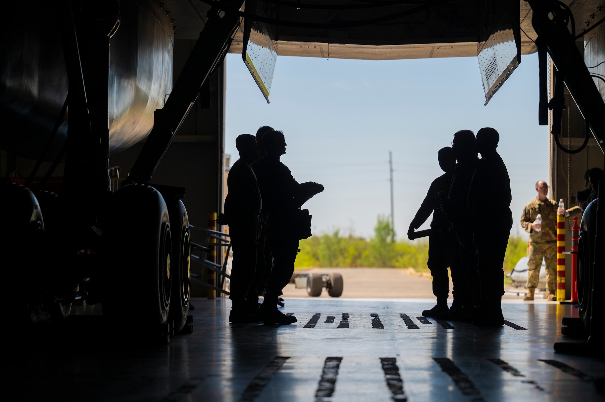 Weapons load crew members assigned to the 7th Aircraft Maintenance Unit prepare to compete in a Load of the Quarter competition at Dyess Air Force Base, Texas, April 14, 2022. Weapons load specialists frequently train to maintain their proficiency on their respective airframes. (U.S. Air Force photo by Senior Airman Colin Hollowell)