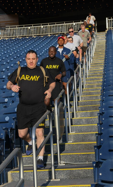 Military members stationed around the National Capital Region run down the stairs during a workout at Nationals Park in Washington, D.C., April 14, 2022.