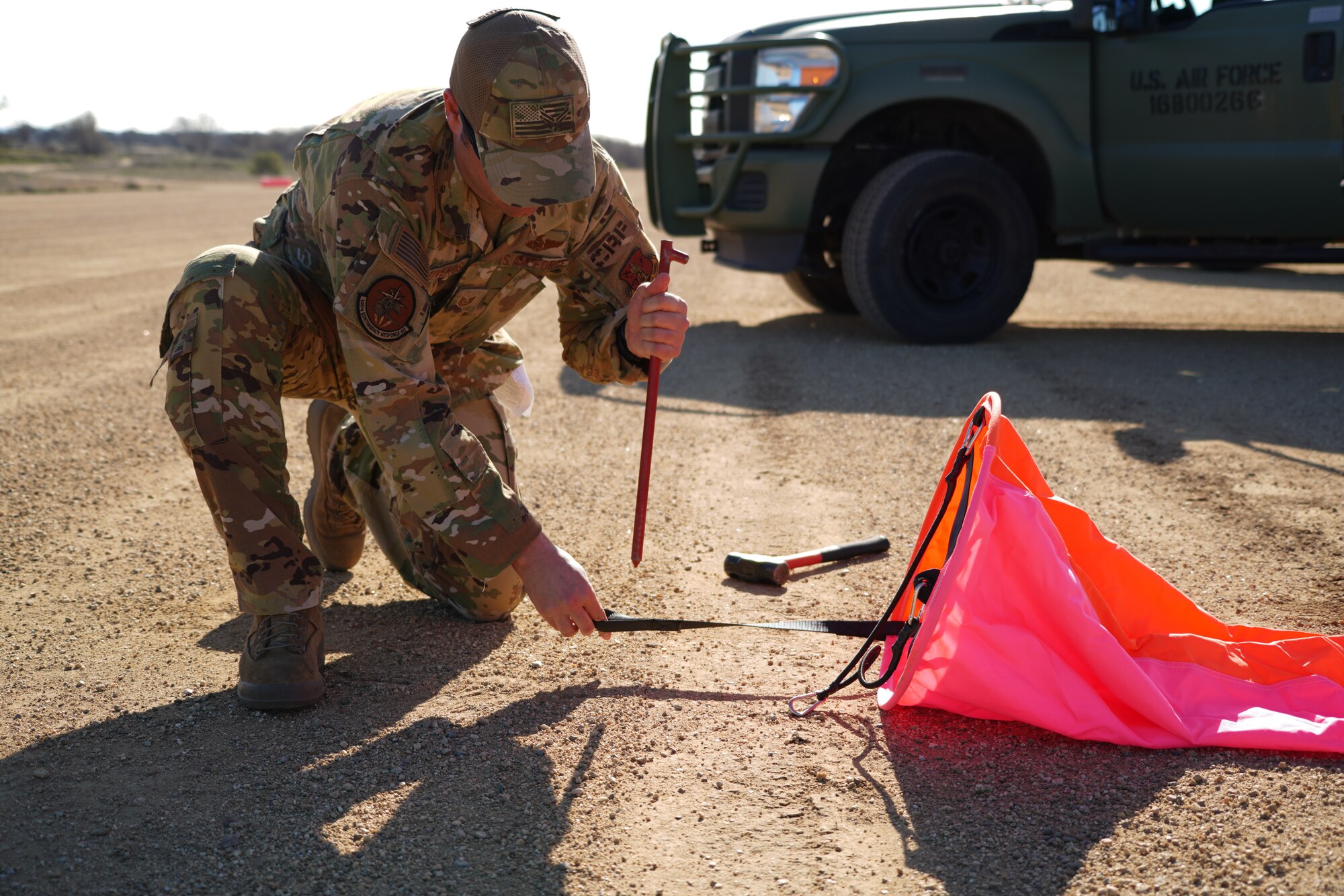 U.S. Air Force personnel assigned to the 621st Contingency Response Wing (621 CRW) load equipment into the back of a C-130J aircraft assigned to the 115th Airlift Squadron on an improvised dirt runway at Fort Hunter Liggett, California, February 8, 2022. Utilizing the C-130J and other Department of Defense aircraft, the 146th Contingency Response Flight and the 621 CRW partnered to accomplish skill-enhancing training and provide airlift support to the 621 CRW's evaluated exercise. (U.S. Air National Guard photo by Staff Sgt. Michelle Ulber)