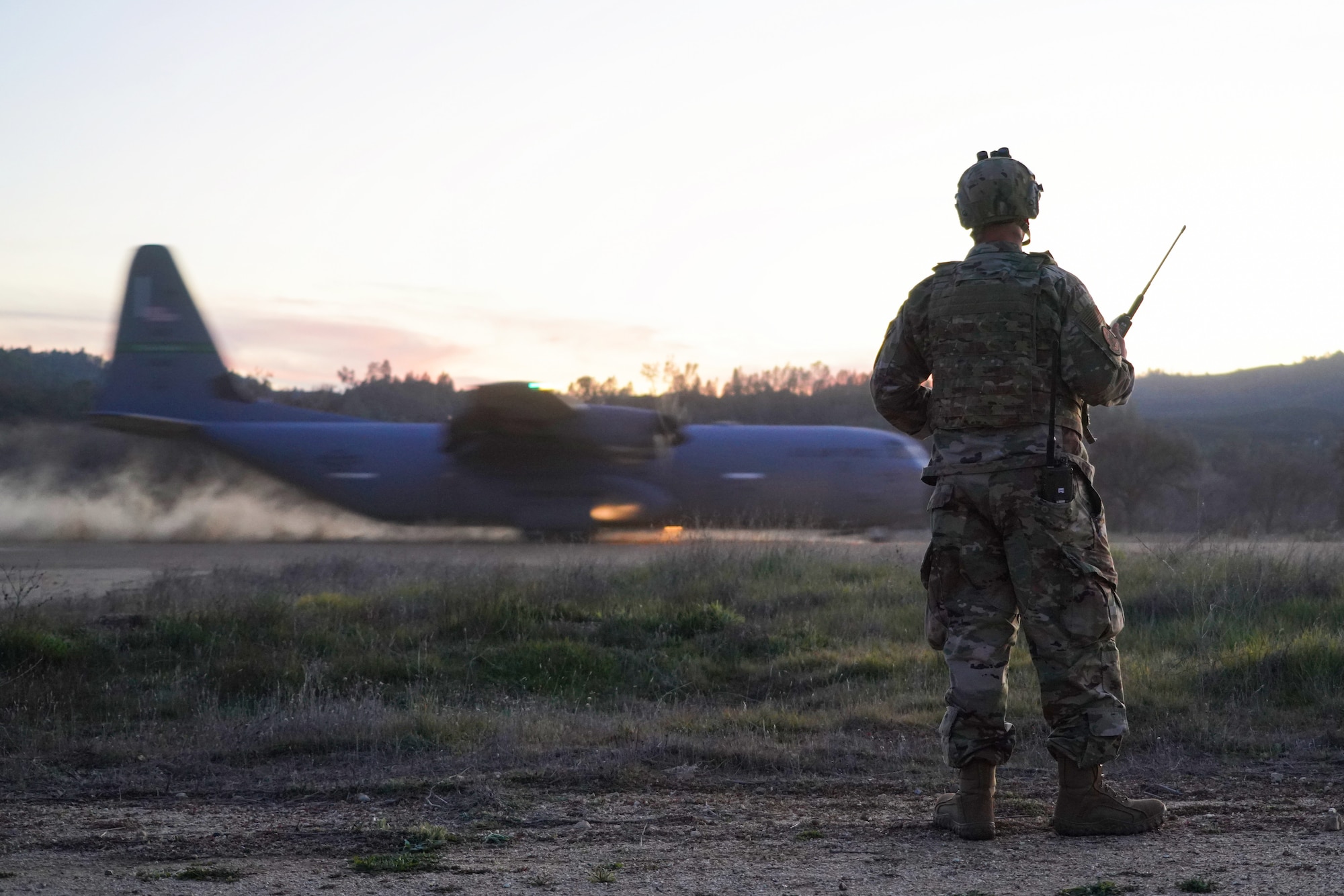 U.S. Air Force personnel assigned to the 621st Contingency Response Wing (621 CRW) load equipment into the back of a C-130J aircraft assigned to the 115th Airlift Squadron on an improvised dirt runway at Fort Hunter Liggett, California, February 8, 2022. Utilizing the C-130J and other Department of Defense aircraft, the 146th Contingency Response Flight and the 621 CRW partnered to accomplish skill-enhancing training and provide airlift support to the 621 CRW's evaluated exercise. (U.S. Air National Guard photo by Staff Sgt. Michelle Ulber)
