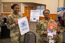From left, Airman 1st Class Nadja Holloway, 341st Force Support Squadron customer support specialist, and Tech. Sgt. Cheiquela Terrazas, 341st Missile Wing resilience trainer, provide resources for parents and Airmen at an education summit April 12, 2022, at Malmstrom Air Force Base, Mont. The education summit aimed to familiarize parents on base with information from local organizations and helping agencies to support their families. (U.S. Air Force photo by Airman 1st Class Elijah Van Zandt)