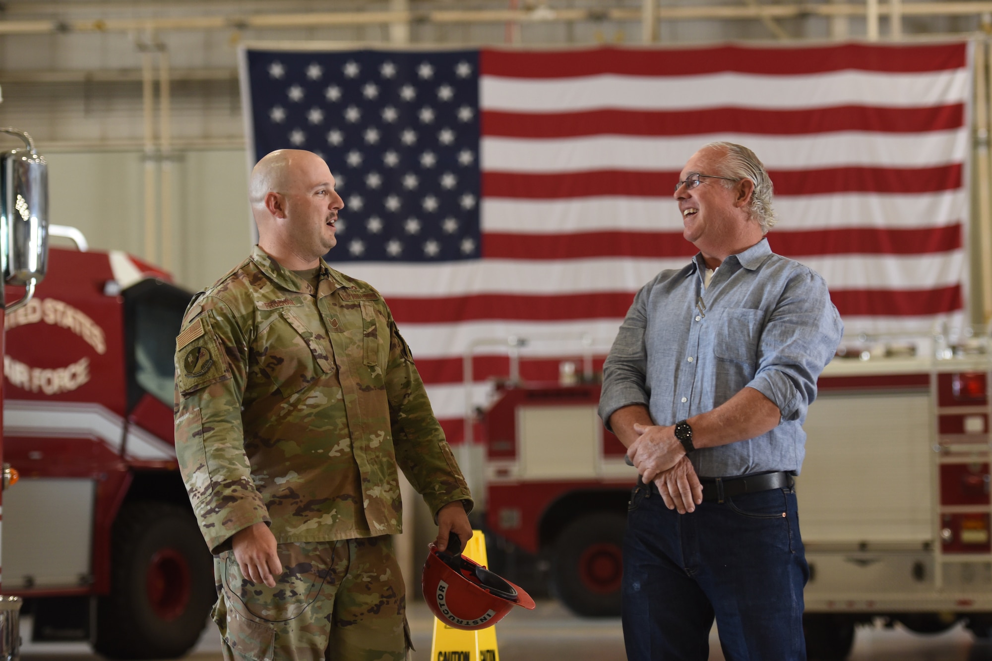 U.S. Air Force Tech. Sgt. Andrew Fruehan, 312th Training Squadron fire instructor and noncommissioned officer in charge, answers questions during the Leadership San Angelo base tour, Goodfellow Air Force Base, Texas, April 14, 2022. The community relations themed tour passed through the Louis F. Garland Department of Defense Fire Academy’s high bay and discussed vehicles used for training on a daily basis such as rescue trucks and aircraft fire fighting vehicles. (U.S. Air Force photo by Senior Airman Abbey Rieves)