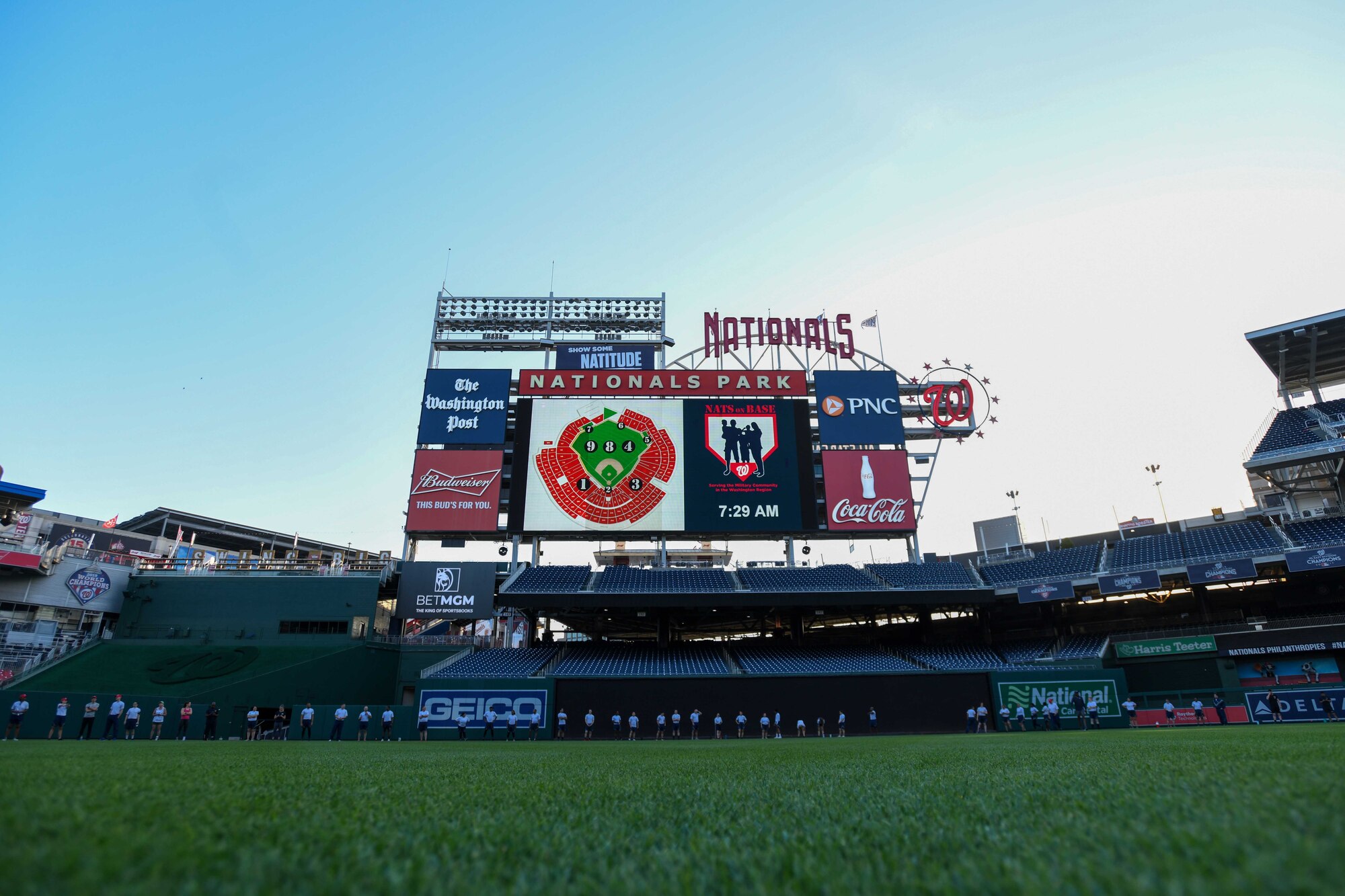 Service members from the National Capital Region do jumping-jacks during high-intensity interval training, known as the Base HIIT Workout, at Nationals Park, Washington D.C., April 14, 2022.