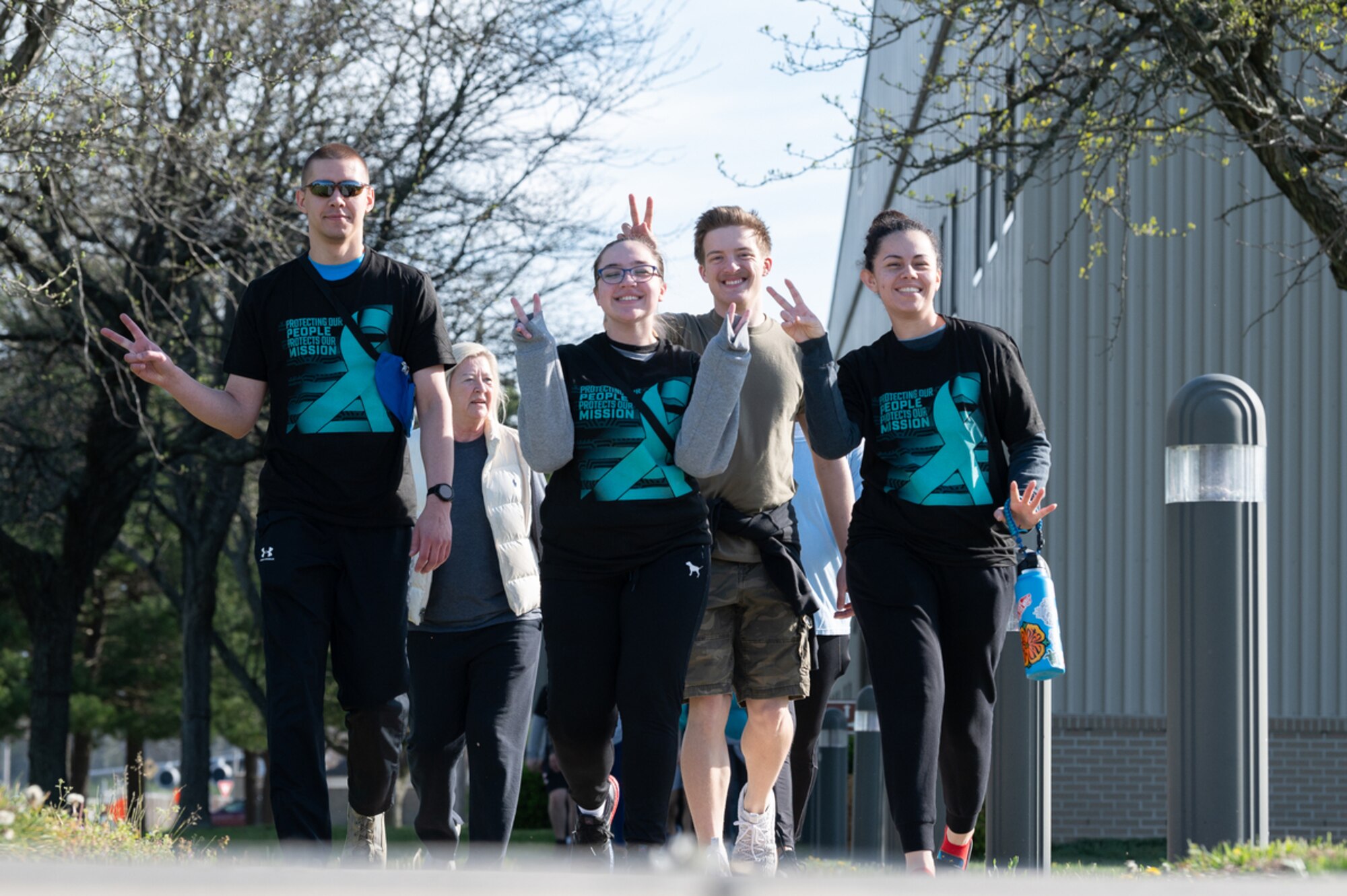 Participants in the 2022 Sexual Assault Awareness Prevention Month Flip Flop 5K Walk approach the end of the course on Dover Air Force Base, Delaware, April 15, 2022. Over 300 Airmen, civilian employees and family members participated in the event. (U.S. Air Force photo by Mauricio Campino)