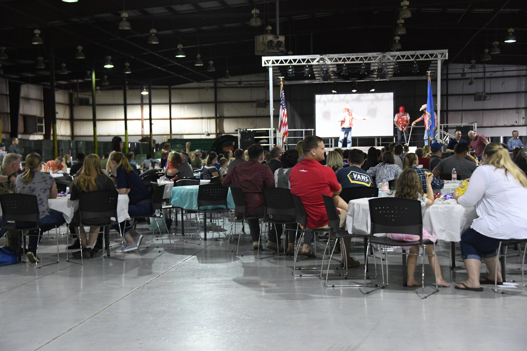 Attendees watch a presentation at the Committee of 100 dinner in Altus, Oklahoma, April 11, 2022. More than 50 people attended the dinner including Airmen, civic leaders and their families. (U.S. Air Force photo by Senior Airman Kayla Christenson)