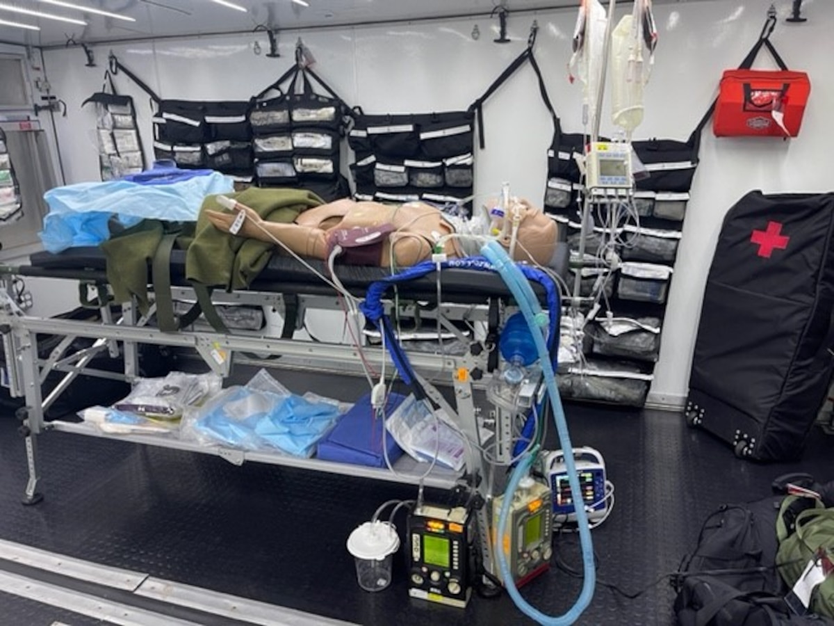A field-type operating room depicts what it is like to work in a Ground Surgical Team with the manikin up off the ground and the GST’s equipment on the ground at the U.S. Air Force School of Aerospace Medicine, Wright-Patterson Air Force Base, Ohio April 8, 2022. The surgical teams work in austere environments and must travel with the tools needed to stabilize patients, which means the teams sometimes work with little to no resources, such as tables, hooks and other common equipment in austere environments. (U.S. Air Force photo by Maj. Thomas Heering)