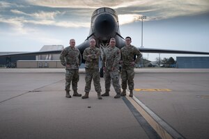 Tech Sgts Narley Wright, Cedric De Bourbon-Poisson, Brandon Morefield, and Nathan Housenga, 7th Maintenance Group load standardization crew members, take a break on the flight line at Dyess Air Force Base, Texas, April 13, 2022.