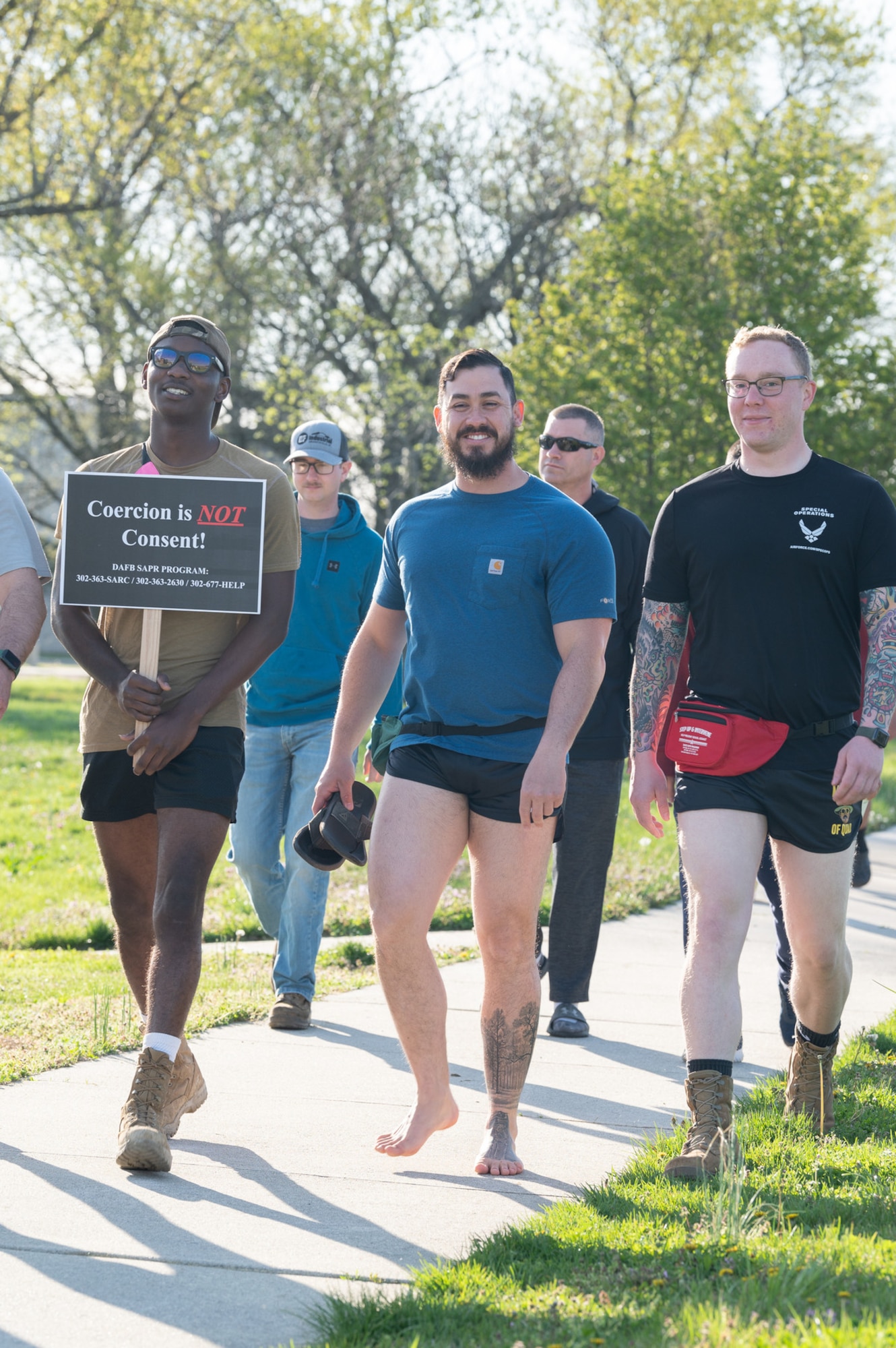 Participants in the 2022 Sexual Assault Awareness Prevention Month Flip Flop 5K Walk approach the halfway point of the course on Dover Air Force Base, Delaware, April 15, 2022. The course measured approximately 14,000 steps, which is the number of sexual assault cases reported annually across the Department of Defense. (U.S. Air Force photo by Mauricio Campino)