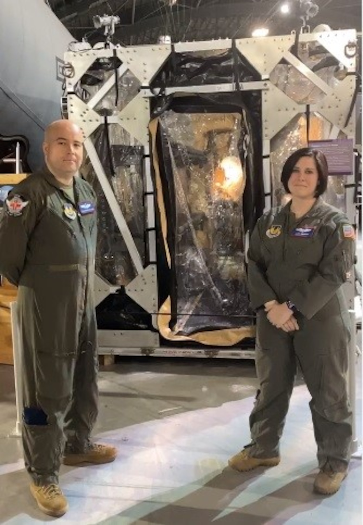 Tech. Sgt. Robert Van Aken and Capt. Alicia Houston, both instructors at the U.S. Air Force School of Aerospace Medicine, stand in front of the Transport Isolation System (TIS) during the grand opening celebration of the National Museum of the U.S. Air Force’s newest permanent exhibit, “A Force for Good: Department of the Air Force Humanitarian Missions,” April 9. (U.S. Air Force photo / Michele Miller)