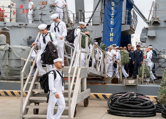 Sailors assigned to the Arleigh Burke-class guided-missile destroyer USS Mitscher (DDG 57), leave on liberty after the ship's return to homeport, Naval Station Norfolk, April 16.