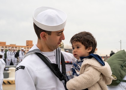 A Sailor assigned to the Arleigh Burke-class guided-missile destroyer USS Mitscher (DDG 57), embraces his son after the ship's return to homeport, Naval Station Norfolk, April 16.